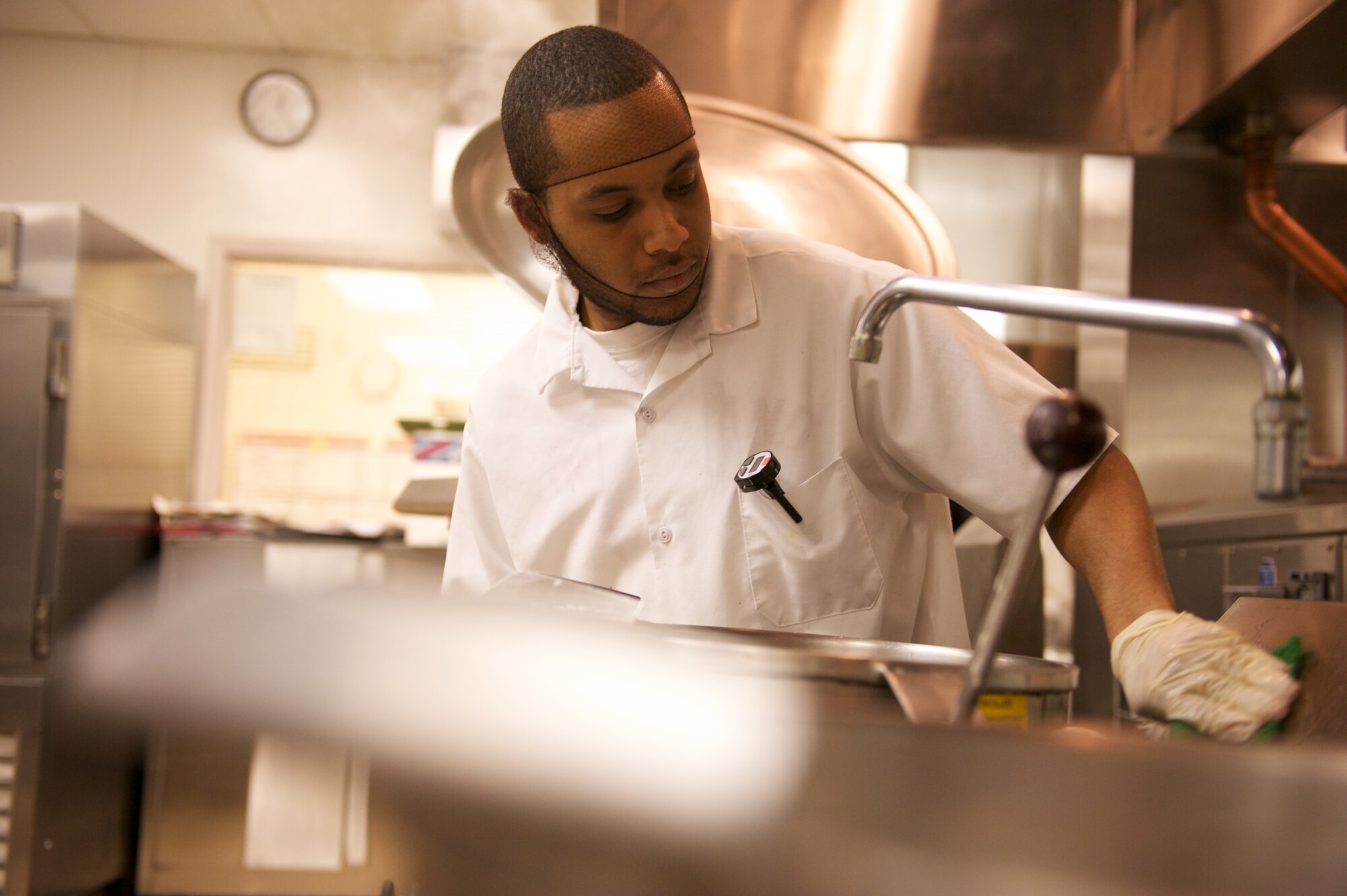 JOINT BASE ELMENDORF-RICHARDSON, Alaska -- Jose Victoriano, Gold Rush Inn Dining Facility, scrubs equipment, Thanksgiving. (Photo by David Bedard/JBER PAO)