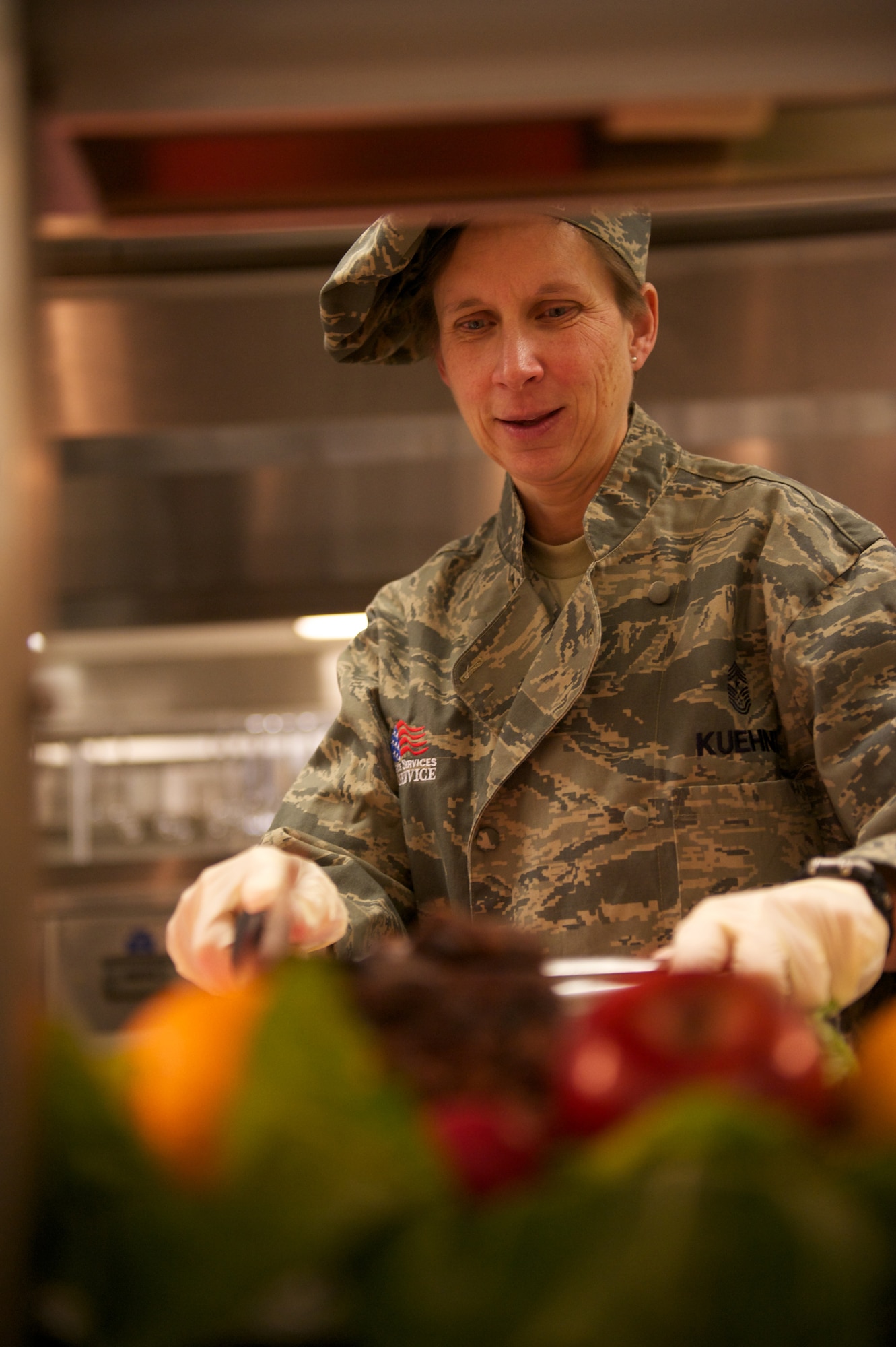 JOINT BASE ELMENDORF-RICHARDSON, Alaska -- Chief Master Sgt. Lisa Kuehnl, 673d Air Base Wing command chief master sergeant, carves cutlets, Thanksgiving, at the Gold Rush Inn Dining Facility. (Photo by David Bedard/JBER PAO)