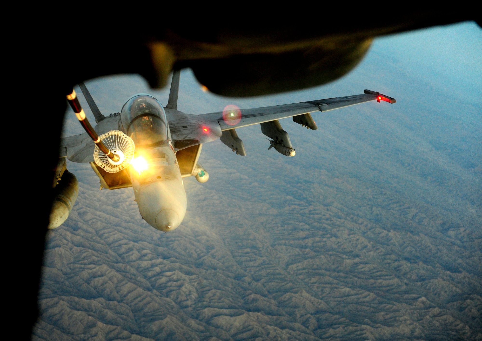 A KC-10 Extender refuels a U.S. Navy F/A-18 Hornet in support of Operation Enduring Freedom while deployed Nov. 25, 2010, over the mountainous terrain in Southwest Asia. The KC-10 is from the 908th Expeditionary Air Refueling Squadron.  (U.S. Air Force photo/Staff Sgt. Andy M. Kin)

