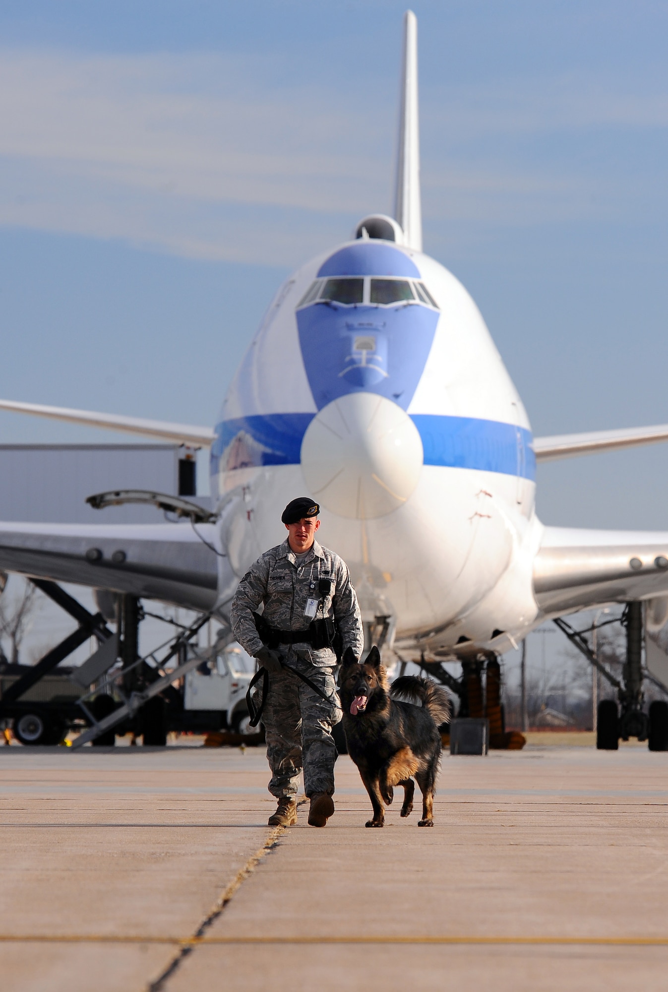 OFFUTT AIR FORCE BASE, Neb. - Staff Sgt. Joel Therrien, a military working dog handler with the 55th Security Forces Squadron, walks down Offutt?s Bravo ramp while doing a routine sweep of the fence line with his dog Dasty, a Belgian Tervuren, Dec. 1.  Dasty is certified by trainers from Lackland AFB to sniff out explosives.  Military working dog teams have led explosive searches for such recent distinguished visitors as the Secretary of Defense, Vice President, First Lady and countless other base visitors and public events.  U.S. Air Force Photo by Josh Plueger (Released)