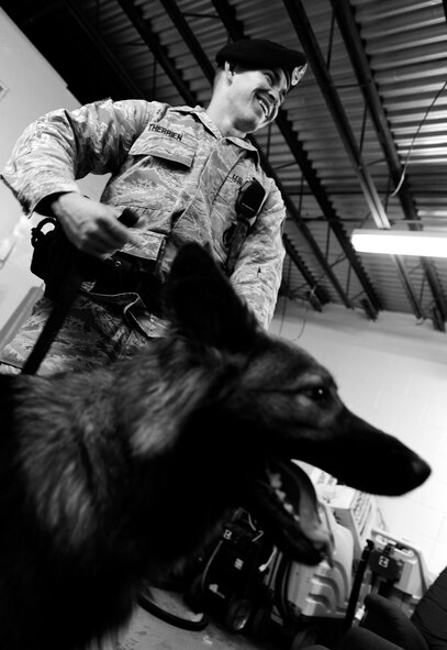 OFFUTT AIR FORCE BASE, Neb. - Staff Sgt. Joel Therrien, a military working dog handler with the 55th Security Forces Squadron, with Military Working Dog Dasty, a Belgian Tervuren , talk with other MWD handlers after a routine explosives and narcotics searching exercise Dec. 1. Dasty is certified by trainers from Lackland AFB to sniff out explosives.  Military working dog teams have led explosive searches for such recent distinguished visitors as the Secretary of Defense, Vice President, First Lady and countless other base visitors and public events. U.S. Air Force Photo by Josh Plueger (Released)