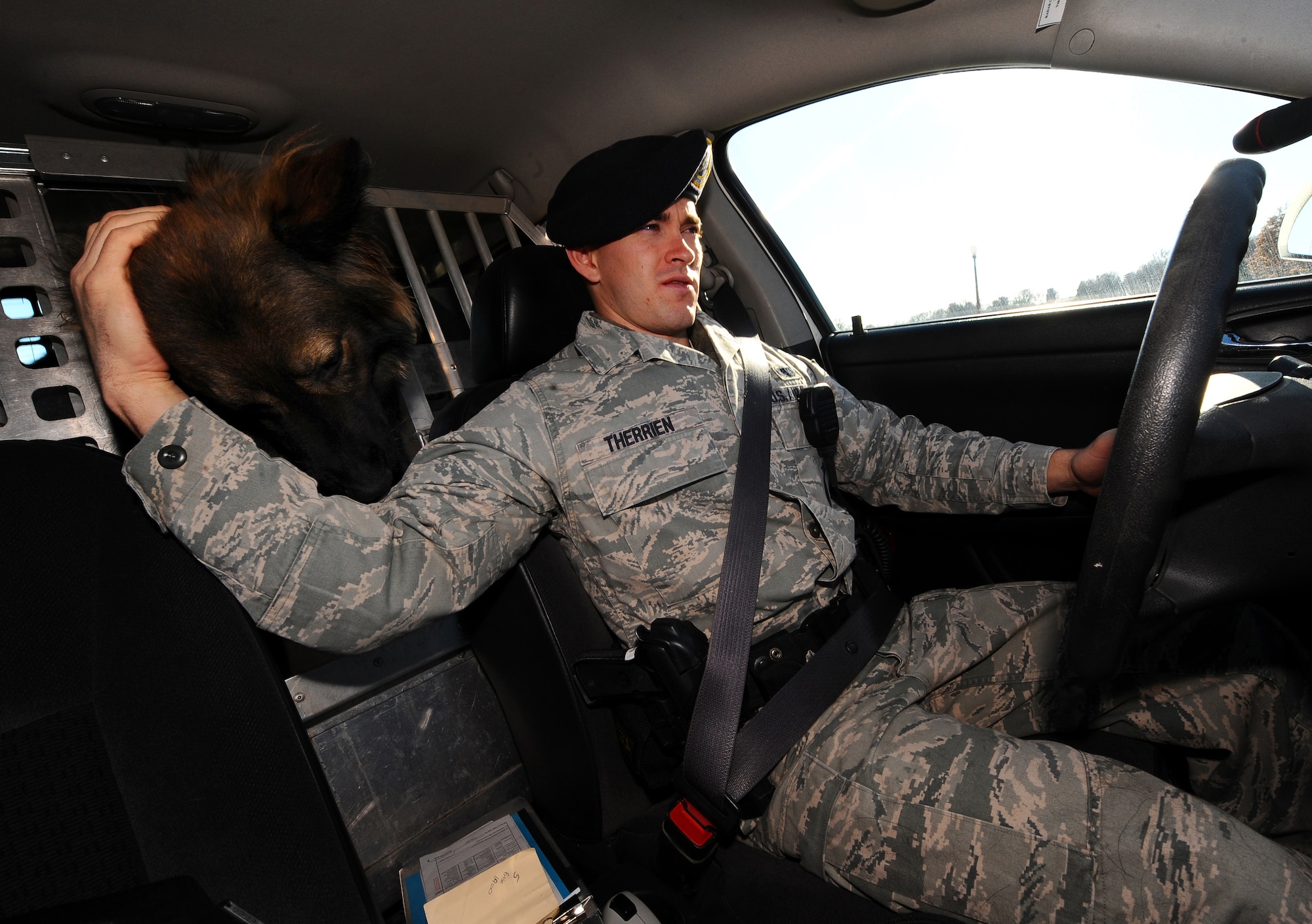 OFFUTT AIR FORCE BASE, Neb. - Staff Sgt. Joel Therrien, a military working dog handler with the 55th Security Forces Squadron, performs his daily patrols of Offutt and military housing with his loyal coworker, an 80 pound Belgian Tervuren named Dasty, at his side Dec. 1.  There is a strong bond between the Sergeant Therrien and Dusty as they spend 12 hours, side by side, driving around the streets of Capehart and Offutt guarding wing assets and protecting the people of Team Offutt.  U.S. Air Force Photo by Josh Plueger (Released)