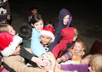 A group of Lackland children light the base Christmas tree at the Gateway Club Dec. 1. The annual Christmas tree lighting ceremony featured a reception in the club ballroom as well as a visit from Mr. and Mrs. Santa Claus. (U.S. Air Force photo/Robbin Cresswell) 
