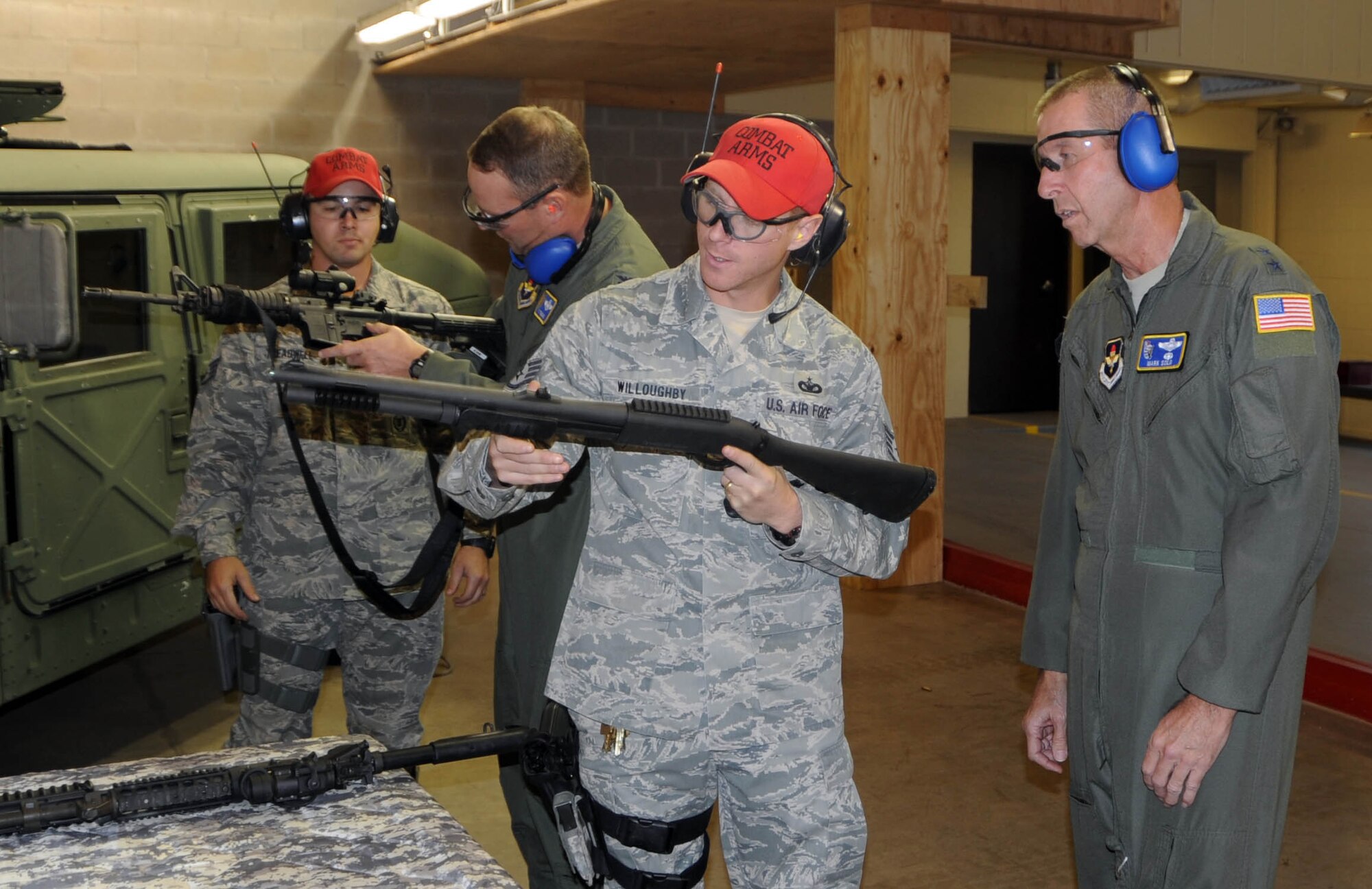 ALTUS AIR FORCE BASE, Okla. - U.S. Air Force Staff Sgt. Robert Willoughby, 97th Security Forces Squadron, and Staff Sgt. Matthew Treadwell, 97th Security Forces Squadron, brief Major General Mark Solo, 19th Air Force commander, and Colonel Ty Thomas, 97th Air Mobility Wing commander, before shooting a 12 guage shotgun and a M4 rifle, Dec. 2. Maj. Gen. Mark Solo was the 97th Air Mobility Wing commander from August 2003 to October 2005. (U.S. Air Force photo by Airman 1st Class Myles Stepp / 97th Air Mobility Wing Public Affairs)