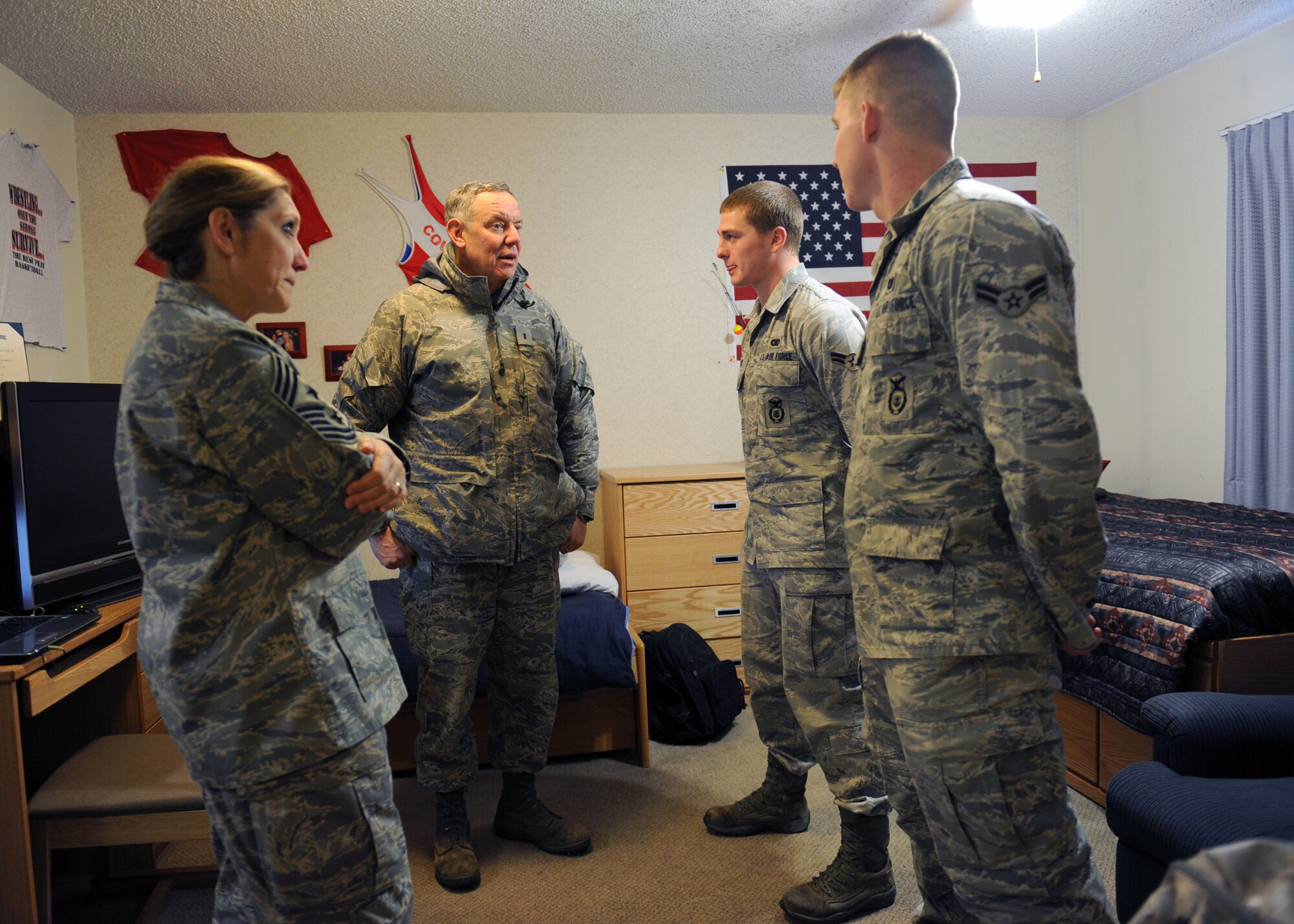 MINOT AIR FORCE BASE, N.D. -- Maj. Gen. C. Donald Alston, 20th Air Force commander, and Chief Master Sgt. Tammy S. Elliott, 20th Air Force command chief, visits the dorm room of Airman 1st Class Dustin Milnes, 91st Missile Security Forces Squadron response force leader, and Airman 1st Class Greg Harris, 5th Security Forces Squadron response force member, to experience what life is like for Airmen who live in a double occupancy room here Nov 30. General Alston and Chief Elliott visited with the men and women of the 5th Bomb Wing and 91st Missile Wing to experience what their quality of life is like during the winter months and to ensure they have the resources available to complete their Air Force Global Strike Command mission. (U.S. Air Force photo/Staff Sgt. Keith Ballard)
