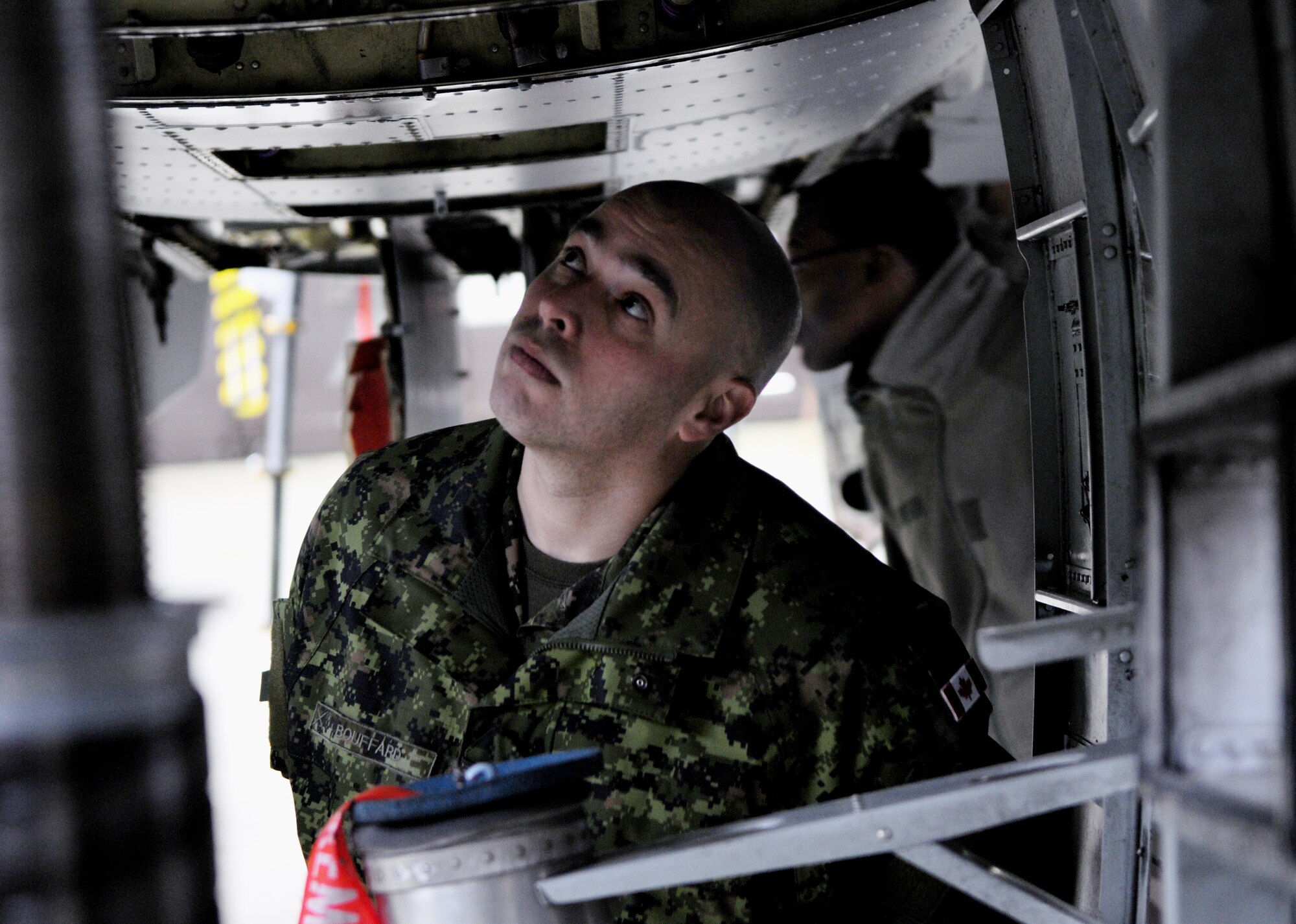 SPANGDAHLEM AIR BASE, Germany – Canadian Master Warrant Officer Eric Bouffard looks underneath an A-10 Thunderbolt II during a NATO visit Dec. 2. Members of NATO Headquarters Allied Air Command at Ramstein Air Base, Germany, visited the 52nd Fighter Wing to familiarize themselves with an American fighter wing and how it operates. (U.S. Air Force photo/Airman 1st Class Matthew B. Fredericks)