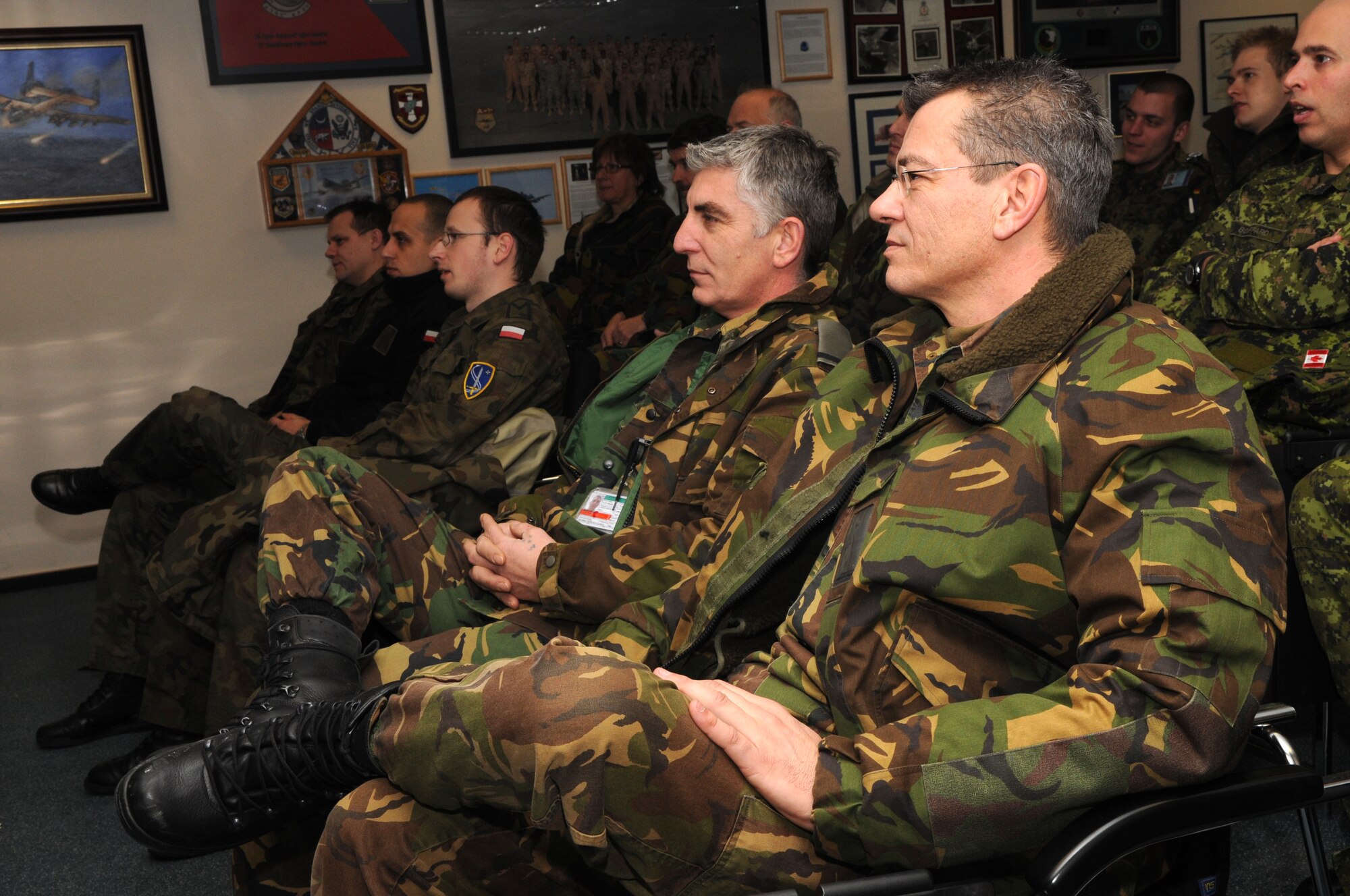 SPANGDAHLEM AIR BASE, Germany – Dutch air force Warrant Officers André Boer and Wen Hendriks watch flight footage from recent missions flown by the 81st Fighter Squadron during a NATO visit Dec. 2. Members of NATO Headquarters Allied Air Command at Ramstein Air Base, Germany, visited the 52nd Fighter Wing to familiarize themselves with an American fighter wing and how it operates. (U.S. Air Force photo/Airman 1st Class Matthew B. Fredericks)