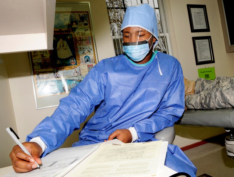 RAF MILDENHALL, England -- Senior Airman Jonahthan Davis, 48th Dental Squadron dental assistant, documents the dentist's findings on a dental treatment form during a patient's yearly exam Dec. 2, 2010. The form is used to track the overall health and any treatments that the patient might need. (U.S. Air Force photo/Senior Airman Ethan Morgan