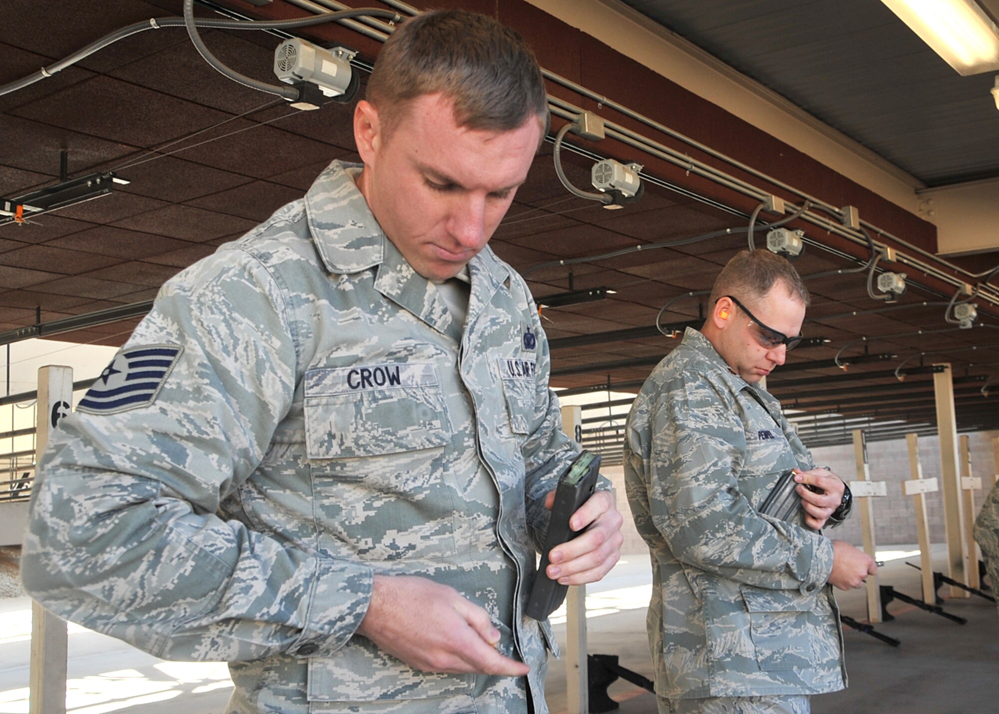 Tech. Sgt. Corey Crow, 377th Security Forces Squadron, loads M-16 rounds.  U.S. Air Force Photo by Todd Berenger.