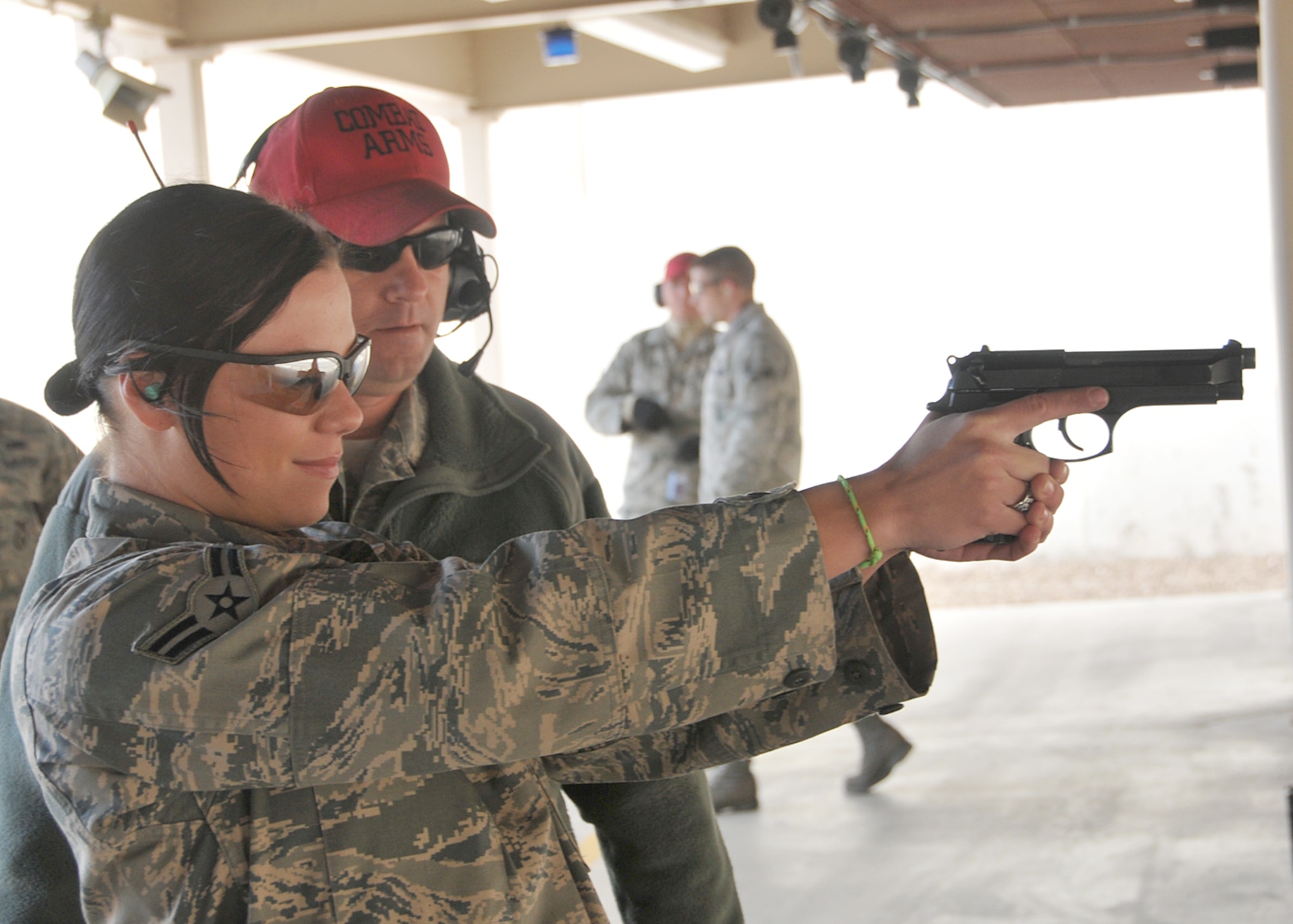 Airman 1st Class Tiffany Westgate, 377th Security Forces Squadron, receives shooting tips from Tech. Sgt. Jason Diamond, Combat Arms instructor, before competing Nov. 24 in the Thanksgiving Excellence in Competition shooting match.  U.S. Air Force Photo by Todd Berenger.