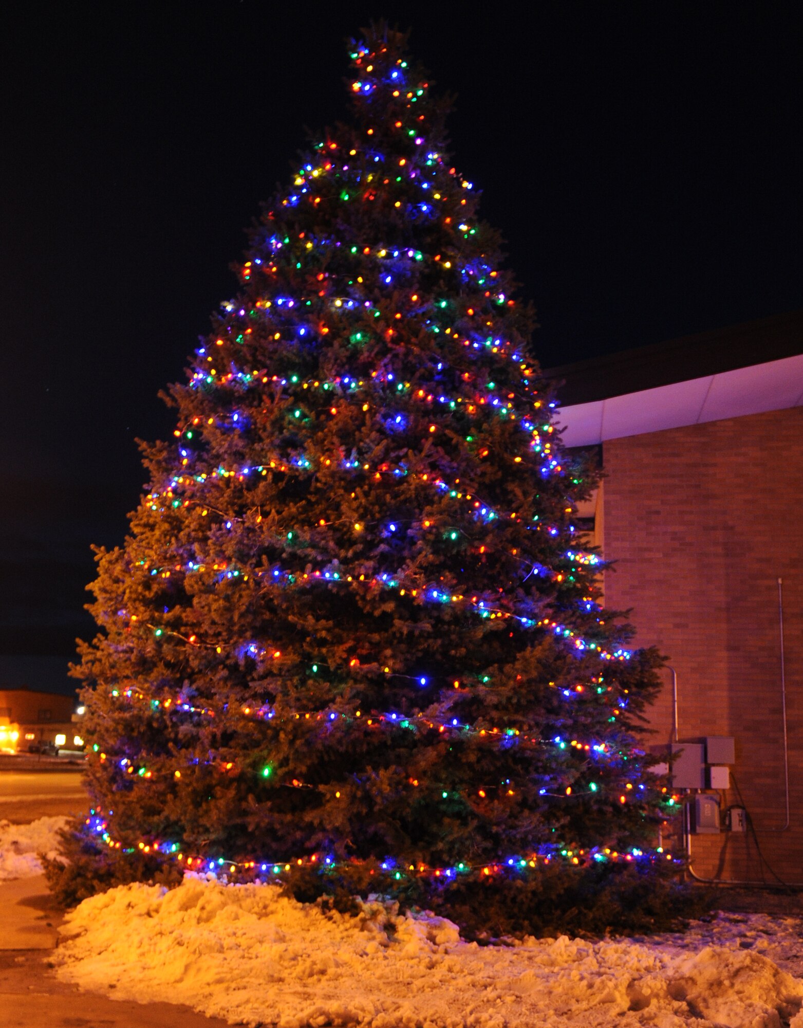 ELLSWORTH AIR FORCE BASE, S.D. -- The base Christmas tree is lit during a ceremony at the Freedom Chapel, Dec 1. The ceremony included Christmas carols sung by more than 65 children from around the base, hot chocolate and even a visit from Santa Claus. (U.S. Air Force photo/Master Sgt. Loren J. Bonser)