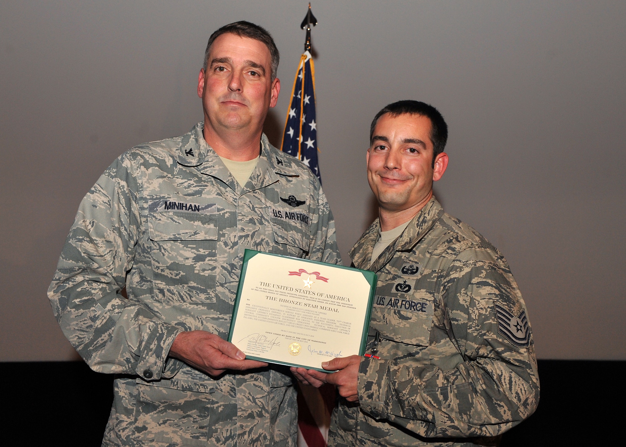 Col. Mike Minihan, 19th Airlift Wing commander, presents Tech. Sgt.  Lawrence Lipinski, 19th Explosive Ordnance Disposal team leader with the Bronze Star Medal here Dec. 2, 2010, at Little Rock Air Force Base, Ark. Sergeant Lipinski distinguished himself through exceptionally meritorious service while deployed in support of Operation Enduring Freedom and the Overseas Contingency Operations as an EOD team leader. Sergeant Lipinski led 66 missions during his deployment to Forward Operating Base Delaram, Afghanistan, supporting Marine combat operations. His team contributed to the destruction of more than 5,200 pounds of bulk explosives greatly reducing the enemy’s main explosive charges used for improvised explosive devices. (U.S. Air Force photo by Senior Airman Gul Crockett)