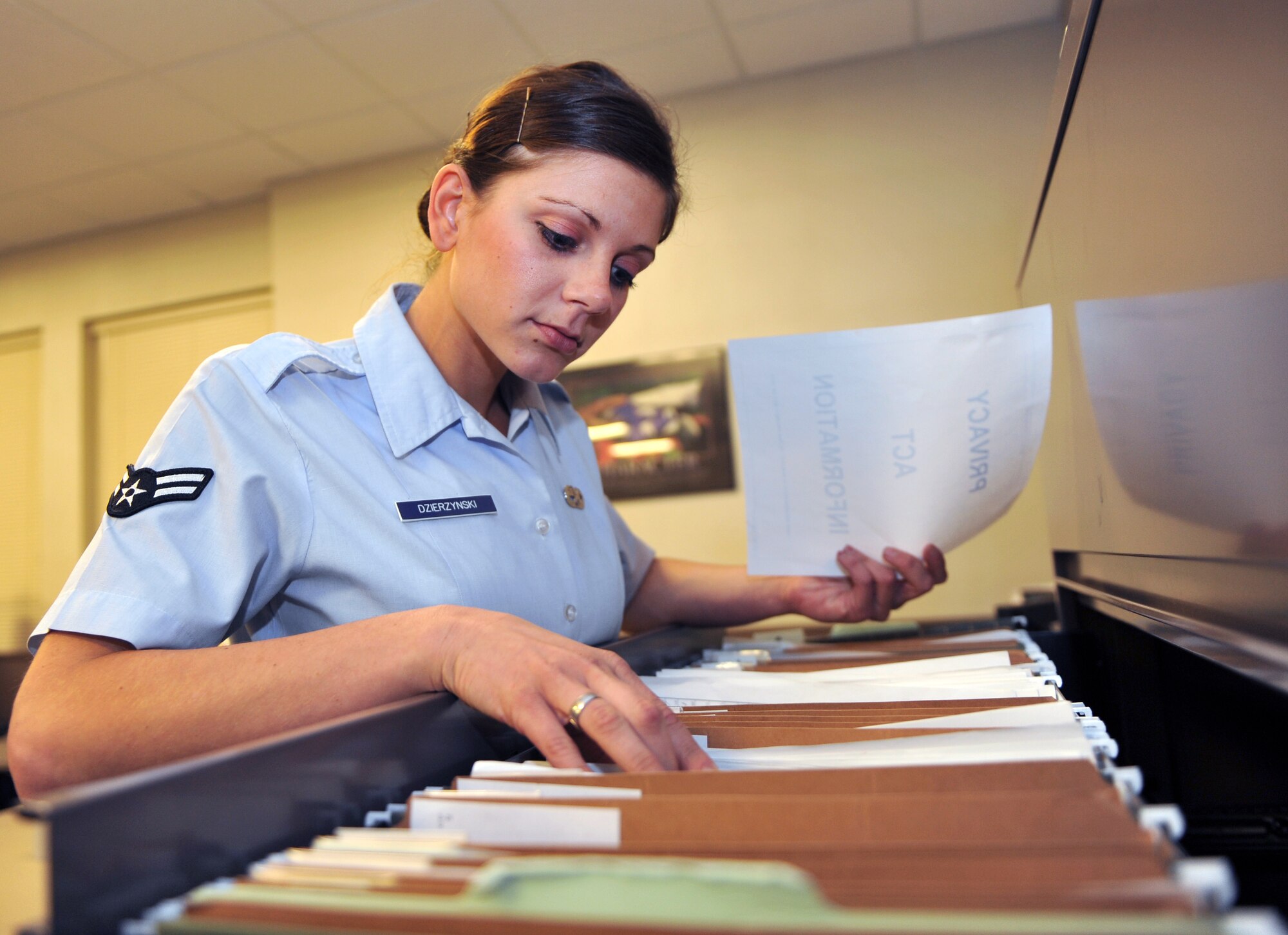 Airman 1st Class Amanda Dzierzynski, a 19th Maintenance Operations Squadron database analyst, files paperwork drawer Nov. 29, 2010, at Little Rock Air Force Base, Ark. The Woodbury, Tenn., native overhauled analysis continuity books creating a flawless reference of more than 200 pages of in-depth instructions and guidance used by flight members. (U.S. Air Force photo by Senior Airman Gul Crockett)