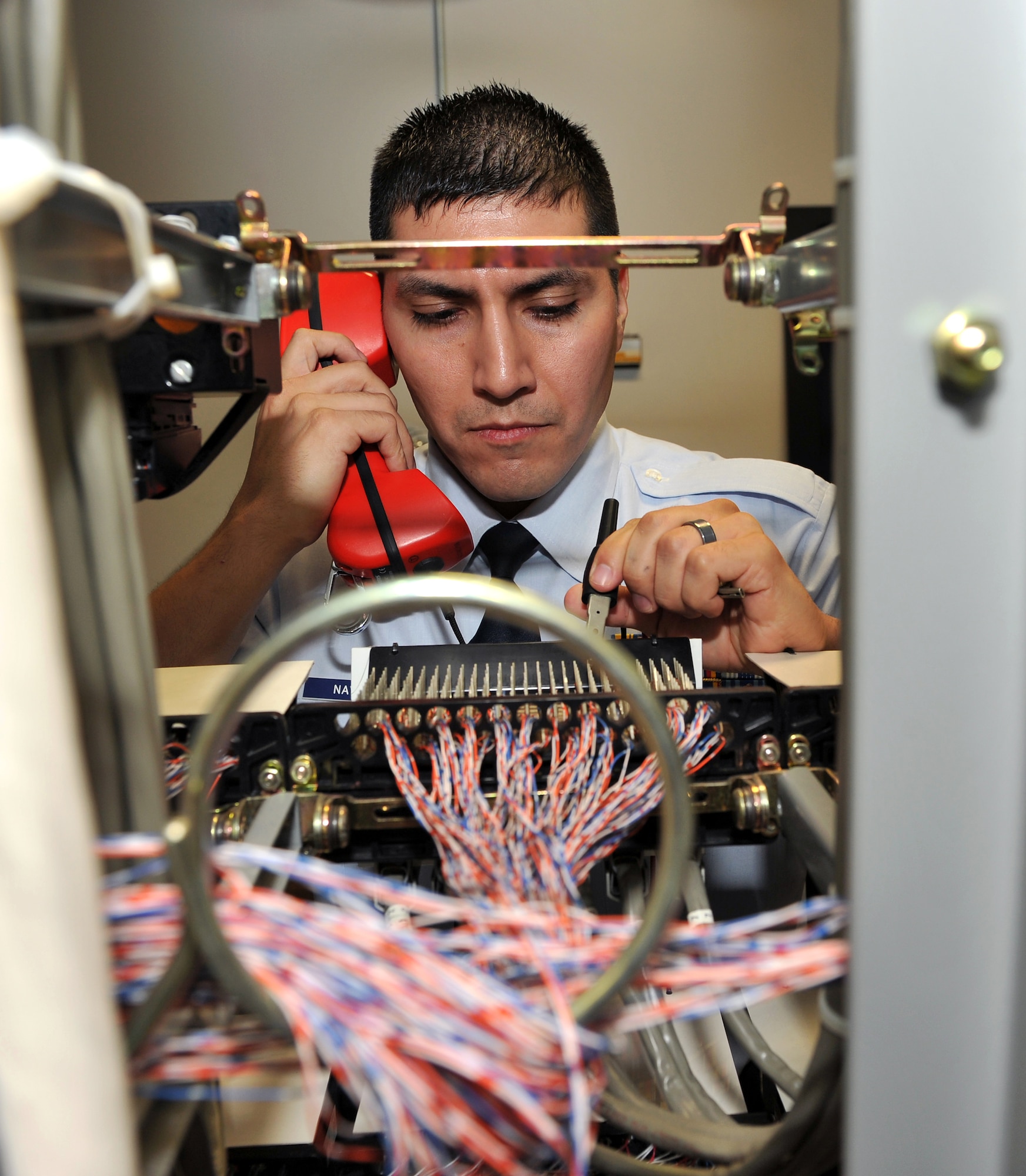 Tech. Sgt. Israel Navarro, a 19th Communication Squadron plans and program manager, checks for a dial tone on a line equipment number block Nov. 29, 2010, at Little Rock Air Force Base, Ark. The 19th CS manages more than 7,000 telephones throughout the base. (U.S. Air Force photo by Staff Sgt. Chris Willis)
