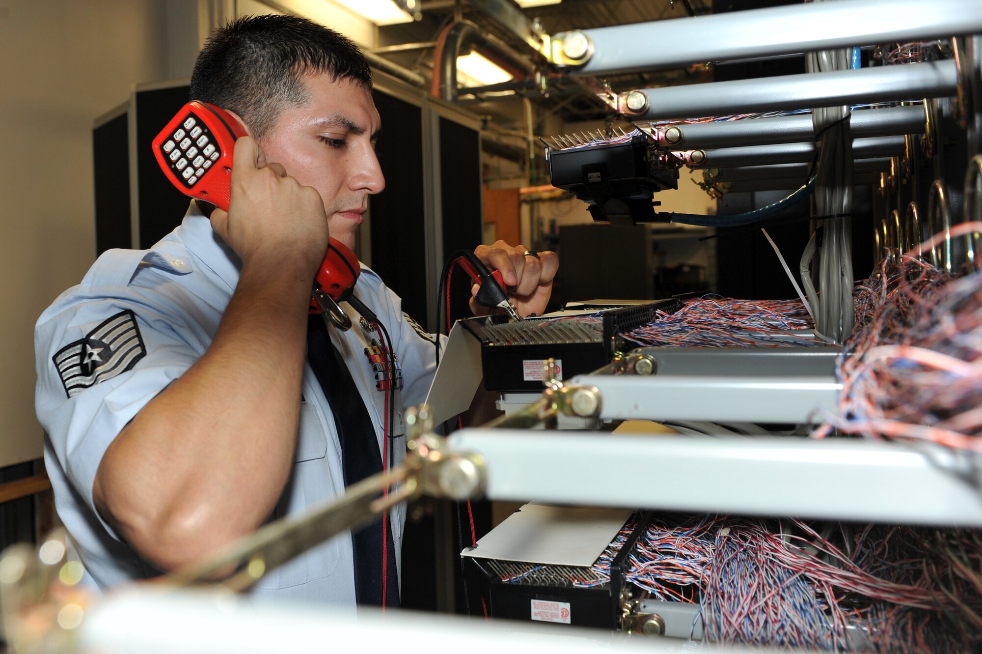 Tech. Sgt. Israel Navarro, a 19th Communication Squadron plans and program manager, checks for a dial tone on a line equipment number block Nov. 29, 2010, at Little Rock Air Force Base, Ark. The 19th CS manages more than 7,000 telephones throughout the base. (U.S. Air Force photo by Staff Sgt. Chris Willis)