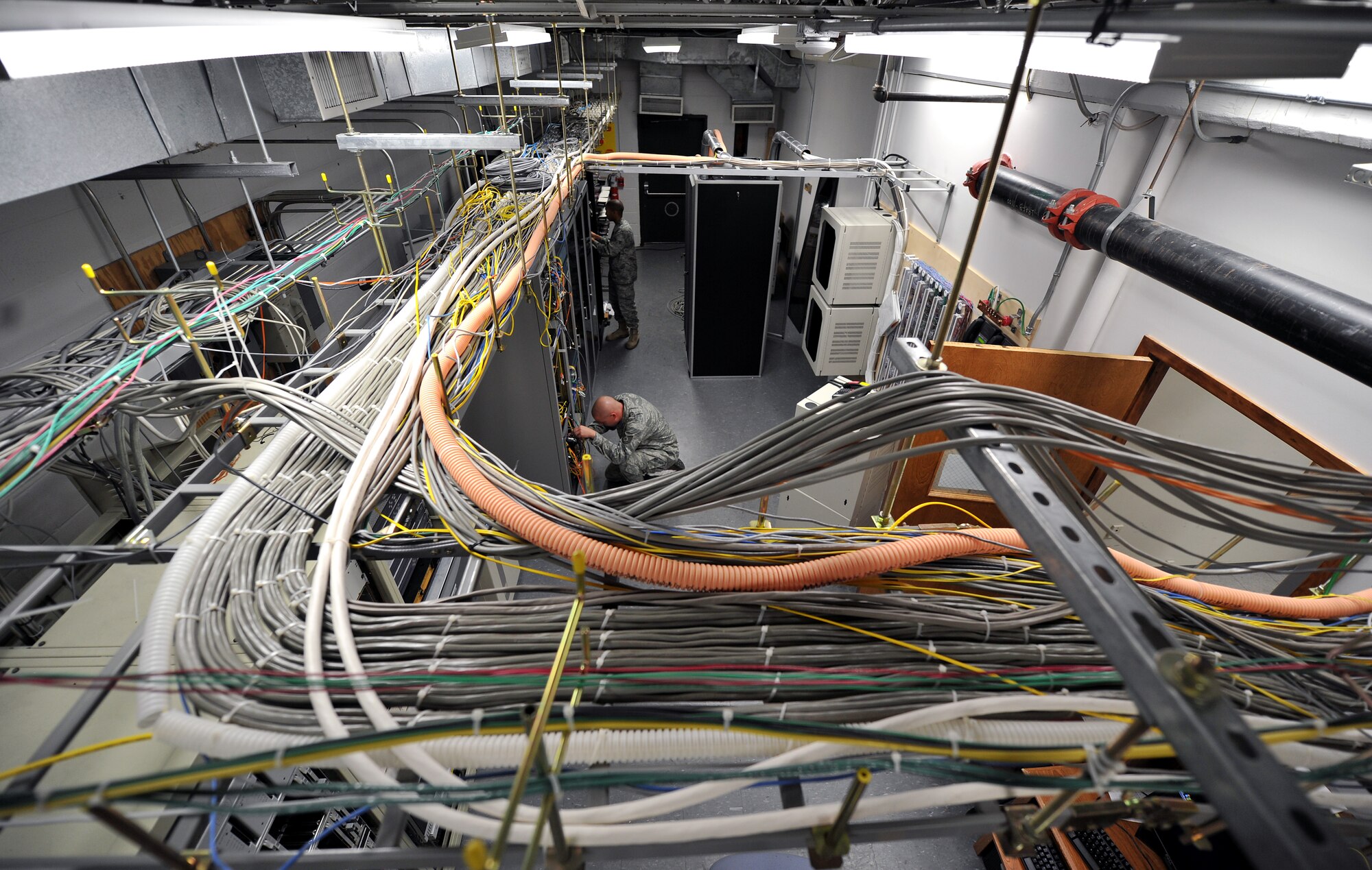 Airmen check network connections in the switch room located at one of the 19th Communication Squadrons buildings Nov. 29, 2010, at Little Rock Air Force Base, Ark. The 19th CS hosts more than 6,200 base internet users. (U.S. Air Force photo by Staff Sgt. Chris Willis)