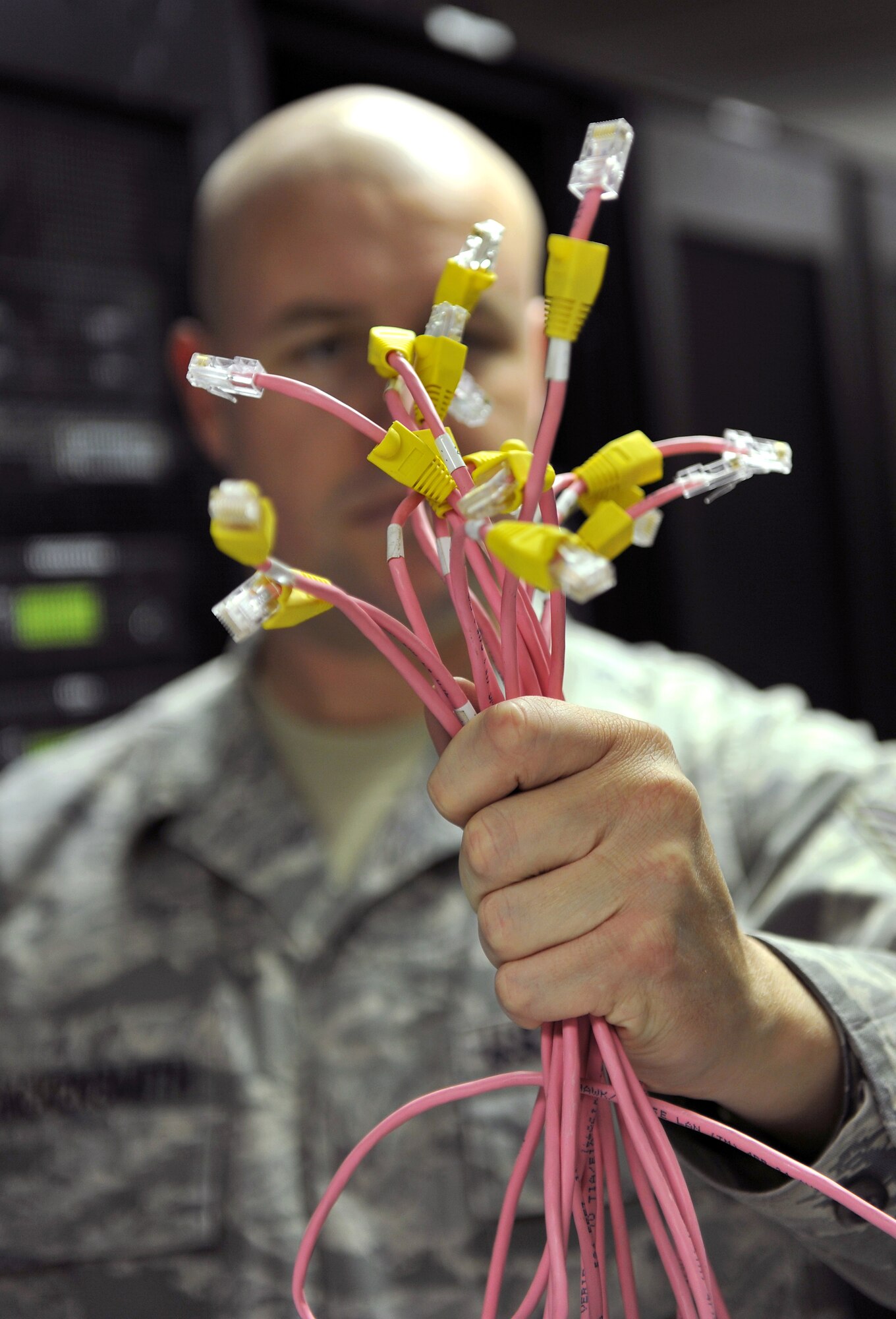 Tech. Sgt. Kenneth Hackensmith, a 19th Communication Squadron cyber systems operator, holds a handful of Cat 5 network cables Nov. 29, 2010, at Little Rock Air Force Base, Ark. The network control center manages 48 ports with more than 250 switches covering all base personnel. (U.S. Air Force photo by Staff Sgt. Chris Willis)
