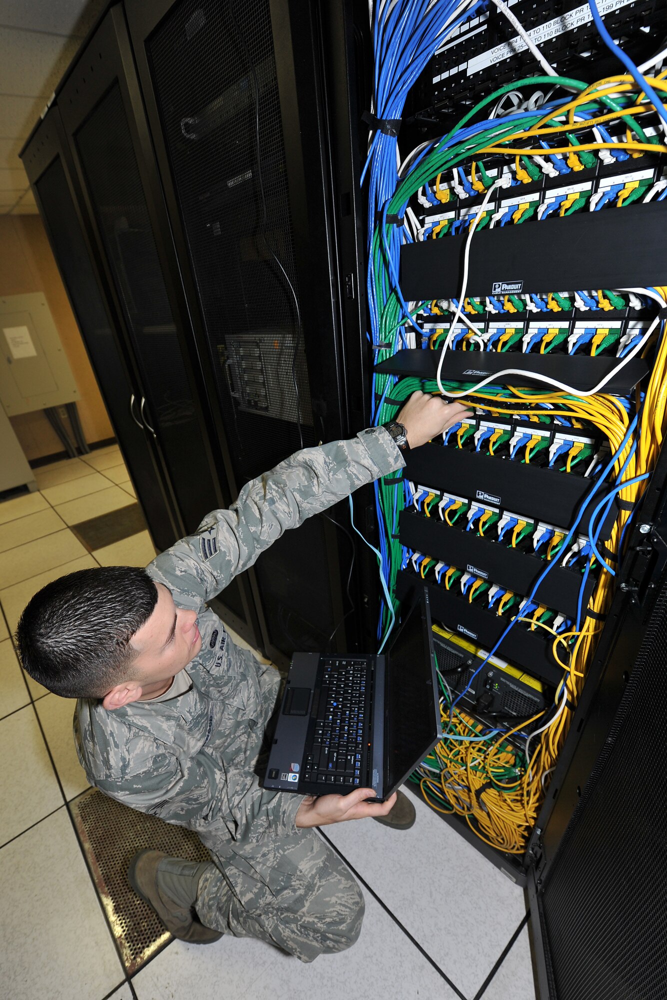 Airman 1st Class Josh Harwood, a 19th Communication Squadron network management technician, configures a port on a switch located at the network control center Nov. 29, 2010, at Little Rock Air Force Base, Ark. The network control center manages 48 ports with more than 250 switches covering all base personnel. (U.S. Air Force photo by Staff Sgt. Chris Willis)
