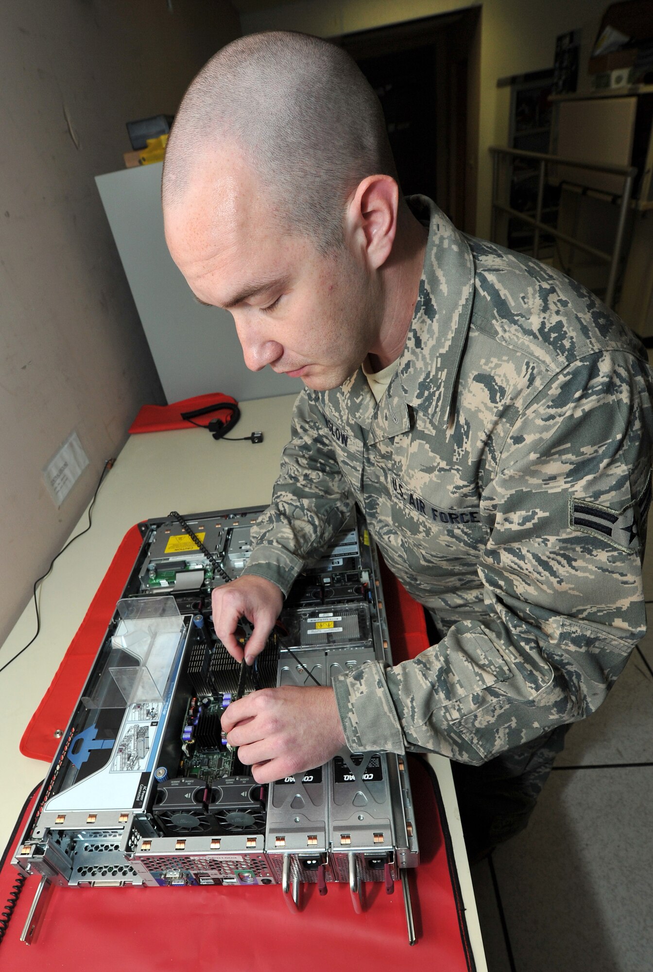 Airman 1st Class Jay Winslow, a 19th Communication Squadron cyber systems operator, upgrades memory on a server in the network control center Nov. 29, 2010, at Little Rock Air Force Base, Ark. The network control center operates more than 70 servers covering all base personnel. (U.S. Air Force photo by Staff Sgt. Chris Willis)