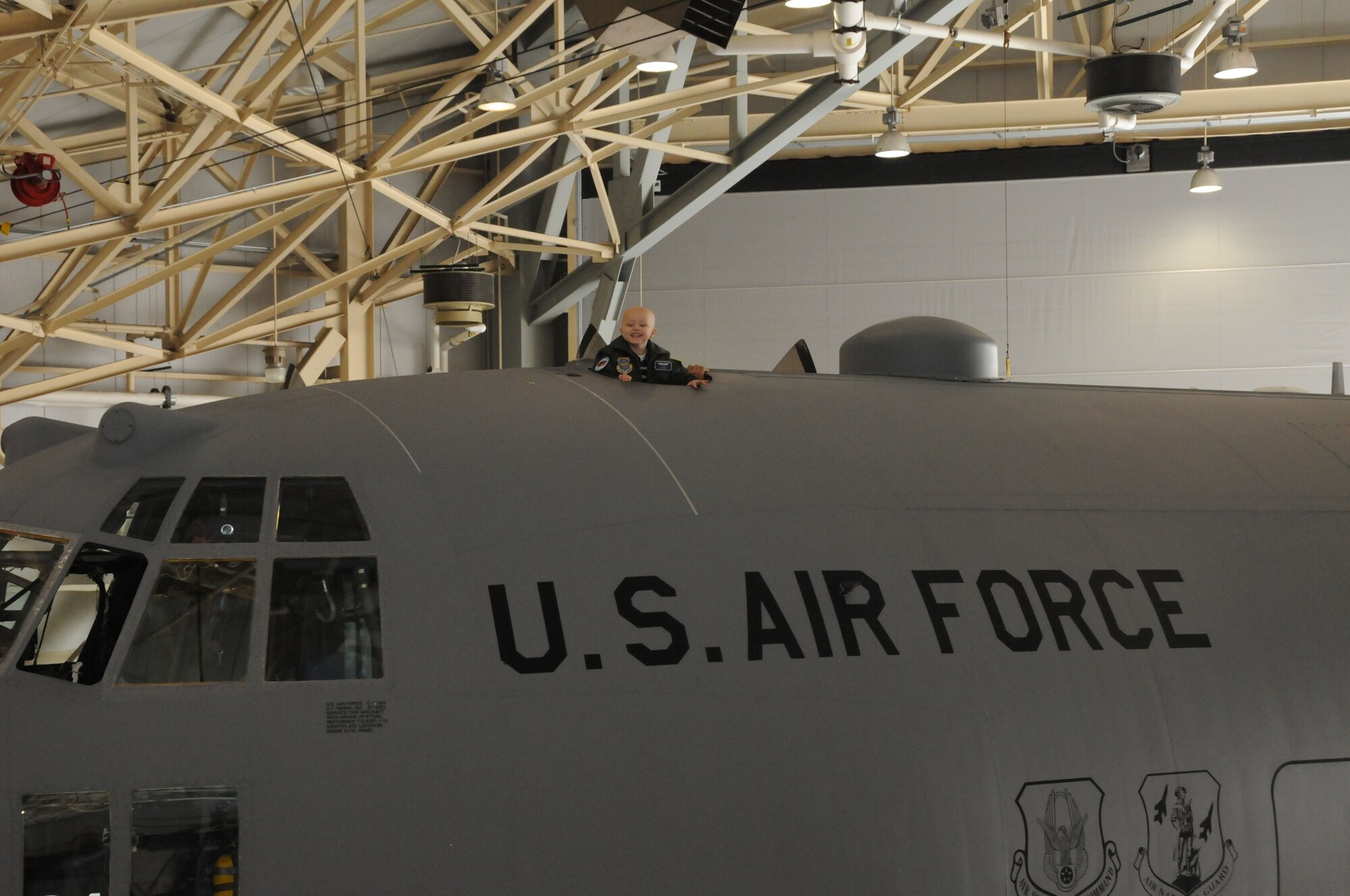 A local 3-year-old boy's dream came true when he reported to the 107th Airlift Wing for the day as an honorary pilot. Logan checks out the top side of a C-130. (U.S. Air Force photo/Staff Sgt. Peter Dean)  