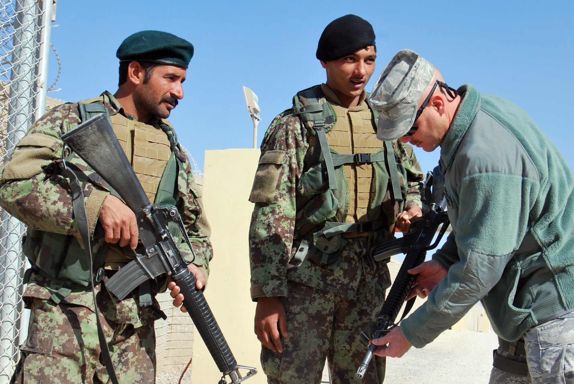 Chief Master Sgt. Dave Staton talks to Afghan Security Force Airmen about weapon cleanliness Dec. 1 at Kandahar Airfield, Afghanistan. Chief Staton is the 738th Air Expeditionary Advisory Group superintendent. As the senior enlisted member, he is also the direct mentor to the Kandahar Air Wing?s enlisted leader, Command Sgt. Maj Mohammad Hassan. (U.S. Air Force photo by Senior Airman Melissa B. White/Released)