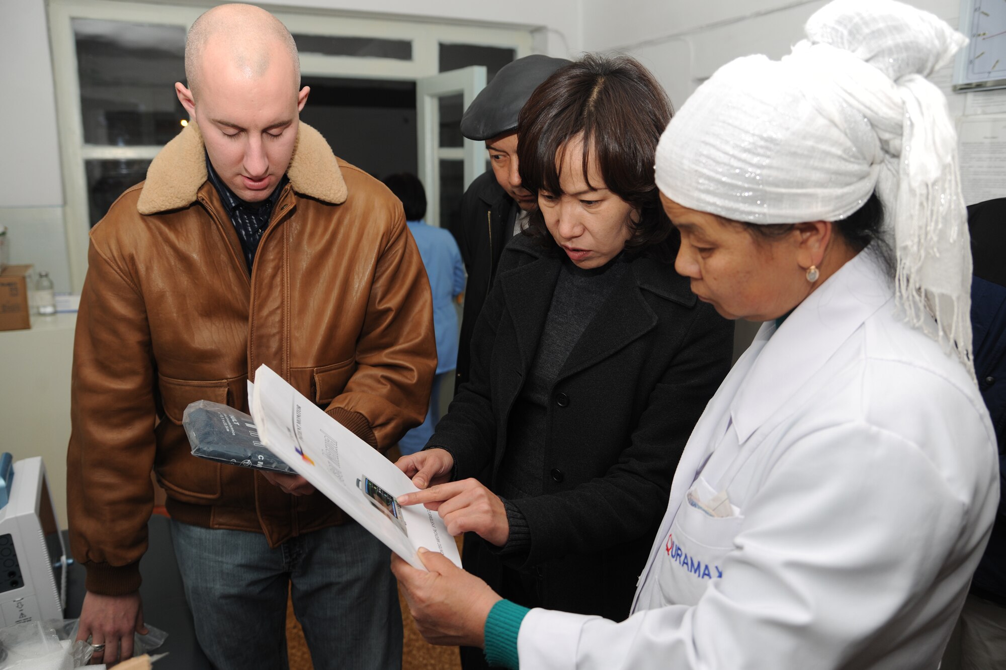TOK MOK VILLAGE, Kyrgyzstan - Capt. Lance Black, 376th Expeditionary Medical Group (EMDG) chief of the medical staff, and Dr. Janyl Sabirova, 376th EMDG translator, provides an intensive care unit monitor to Chui Regional Hospital Dec. 1.  The EMDG has worked with this hospital since September 2010 to improve current facilities through construction and material supplies.   (U.S. Air Force photo/Staff Sgt. Nathan Bevier)