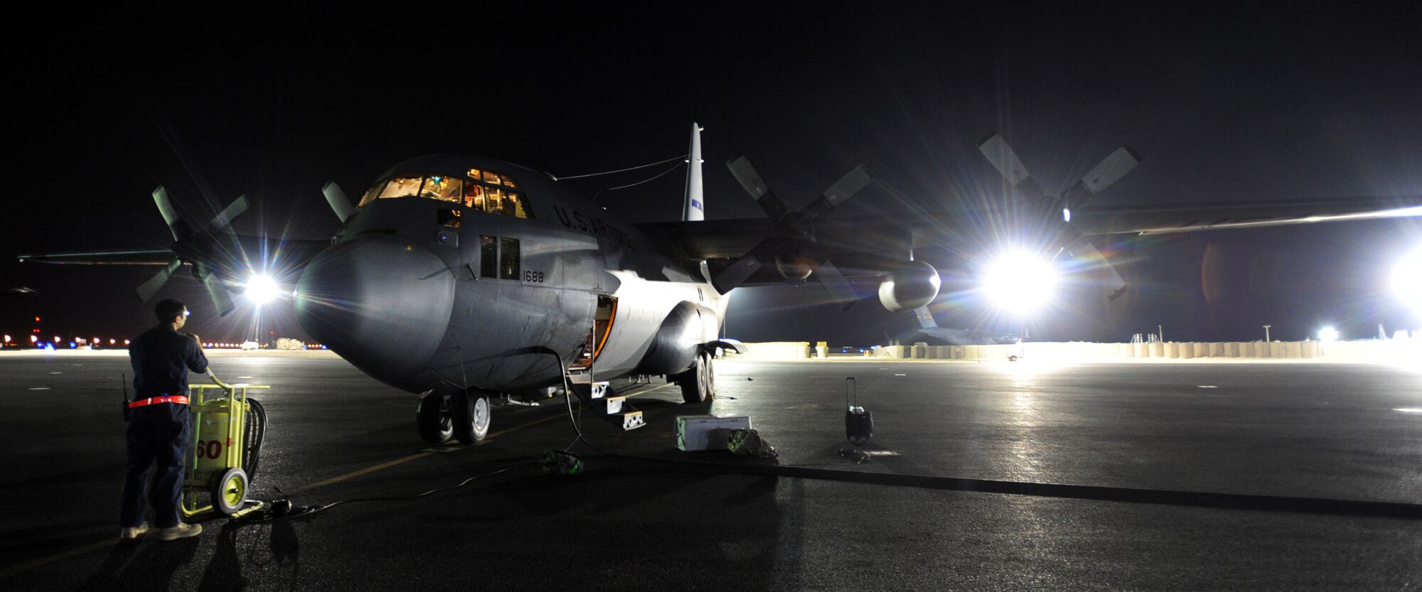 SOUTHWEST ASIA – The crew of a C-130 Hercules assigned to the 386th Air Expeditionary Wing prepares for a night mission at an undisclosed air base here Nov. 27, 2010. The C-130 is used primarily for tactical airlift and can operate from dirt strips in austere locations. Five decades have passed since the Air Force issued its original design specification, yet the C-130 remains an essential transport aircraft for moving troops and cargo across the U.S. Central Command’s Area of Responsibility. (U.S. Air Force photo by Senior Airman Laura Turner)