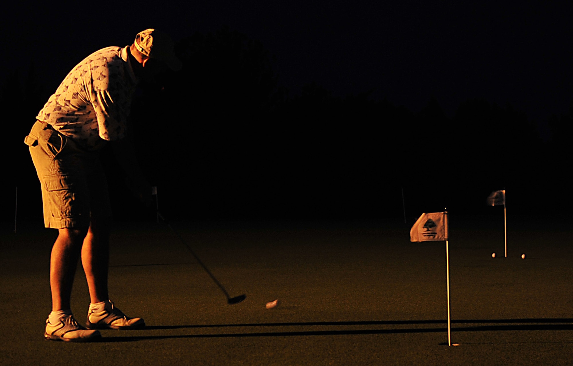 A participant in the Combined Federal Campaign golf tournament practices putting at the Banyan Tree Golf Course Dec. 3. The tournament received $614 in donations to be given to the Family Support Youth Programs on Kadena. (U.S. Air Force photo/Staff Sgt. Alesia Goosic)