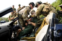 United States Air Force Staff Sgt. Matt Ritchie and 1st Lt. Brian Carey, 31st Rescue Squadron, pararescuemen pulls out Japan Self-Defense Forces Master Sgt. Hiroki Kumasaka a vehicle during extraction training Dec. 3. The extraction training was part of Keen Sword to bring together United States Air Force and Japan Self-Defense Forces pararescue men to train and share techniques on vehicle extraction. Keen Sword 2011 will include an estimated 10,500 U.S. participants from the Army, Navy, Air Force and Marines. Significant training events during Keen Sword 2011 will include integrated air and missile defense, base security and force protection, search and rescue, close air support, live-fire training, and maritime defense and interdiction.(U.S. Air Force photo/Staff Sgt. Jonathan Steffen)