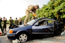 United Stated Air Force Staff Sgt. Matt Ritchie, 31st Rescue Squadron, a pararescue man cuts through a windshield during vehicle extraction training Dec. 3. The extraction training was part of Keen Sword to bring together United States Air Force and Japan Self-Defense Forces pararescue men to train and share techniques on vehicle extraction. Keen Sword is designed to allow the United States and Japan to practice and evaluate the coordination procedures and interoperability elements required to effectively and mutually respond to the defense of Japan, or to a regional crisis or contingency situation in the Asia-Pacific region, while building bilateral confidences and working relationships. .(U.S. Air Force photo/Staff Sgt. Jonathan Steffen)