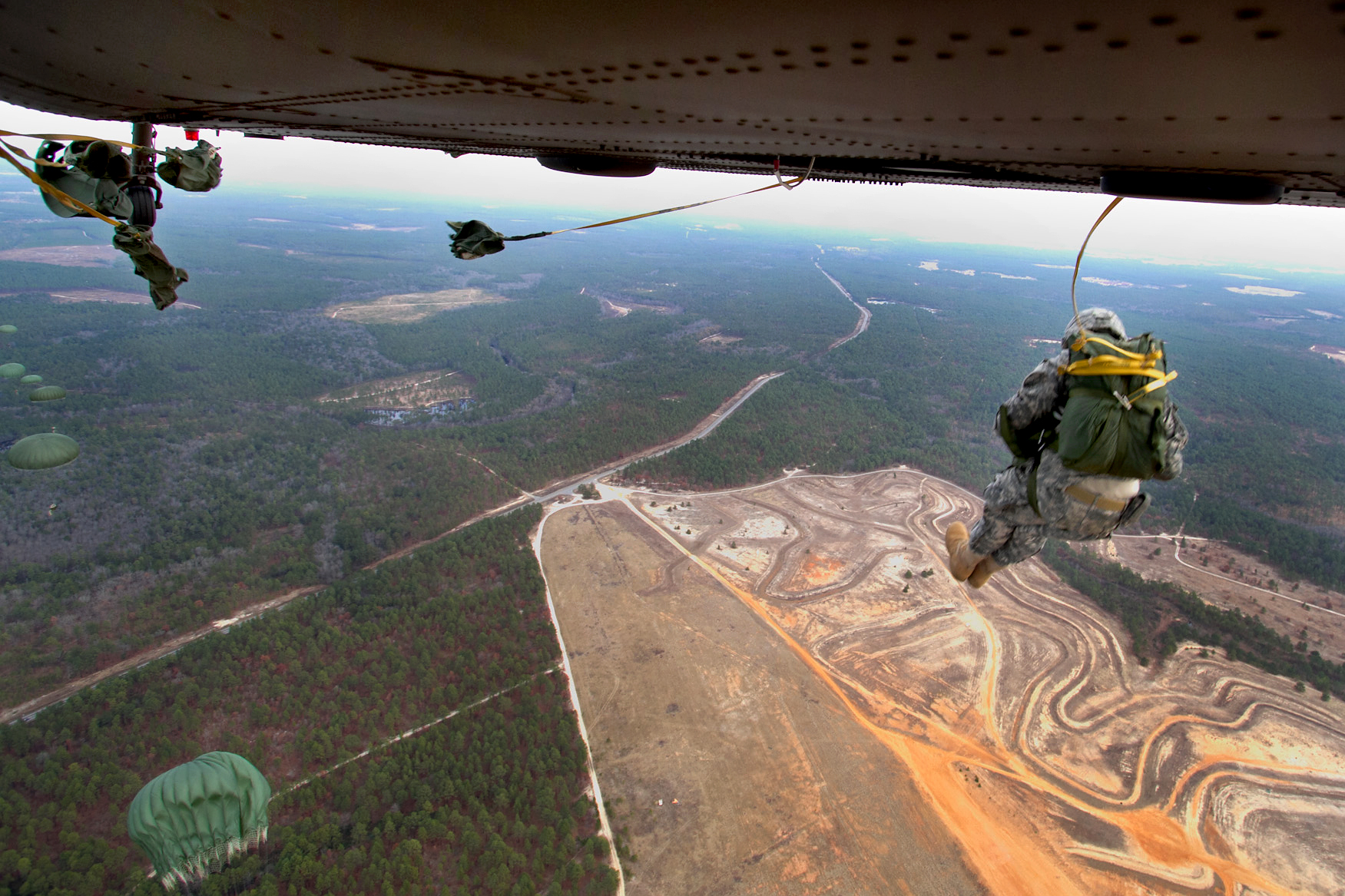 U.S. Army paratroopers jump from a UH60M Black Hawk helicopter during