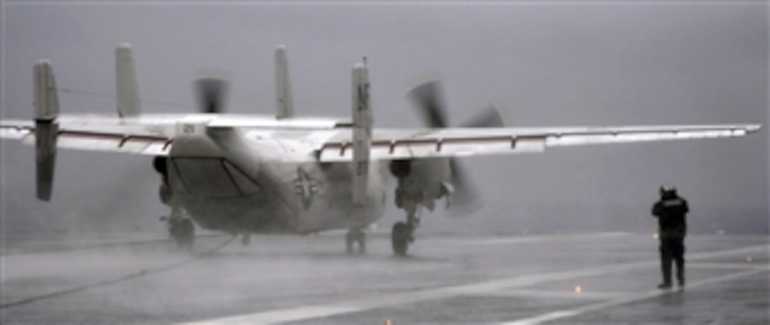 A U.S. Navy C-2A Greyhound aircraft assigned to Carrier Logistic Support Squadron 30 lands aboard the aircraft carrier USS George Washington (CVN 73) while underway west of the Korean peninsula on Dec. 2, 2010.  
