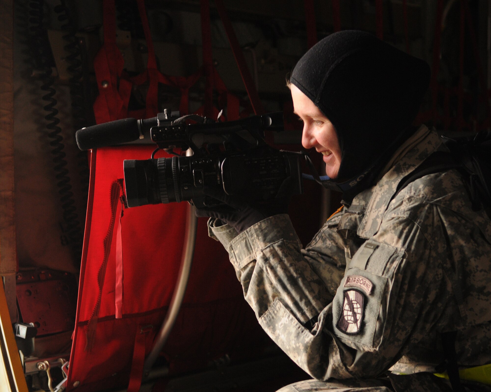 RAMSTEIN AIR BASE, Germany -- Army Spc. Amber Stephens, U.S. European Command Combat Camera, captures video from a C-130J Super Hercules while documenting the response to wildfires near Haifa, Israel, Dec. 4. U.S. Air Forces in Europe began airlifting 20 tons of fire retardant to Israel in a joint effort to provide humanitarian assistance combating the worst wildfires in the nation's history. EUCOM purchased the fire retardant and began a mission following an official request from the Israeli government for support. (U.S. Air Force photo/Staff Sgt. Benjamin Wilson)