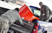 Members of the Air Force Reserve's 39th Aerial Port Squadron move a modified C-130 Hercules paratroop door onto an aircraft pallet position Dec. 4 at Peterson Air Force Base, Colo. The Airmen were supporting last-minute loading of the U.S. Forest Service Modular Airborne Fire Fighting System equipment and accessories as part of a 302nd Airlift Wing deployment to Israel to help battle raging wildfires there. The wing, the only aerial firefighting organization in the AF Reserve, received its orders late Dec. 3 to ready approximately 50 personnel and two aircraft to deploy on short notice to help fight a more than 7,000 acre fire burning out of control near Israel's third-largest city, Haifa. (U.S. Air Force photo/Staff Sgt. Stephen J. Collier)