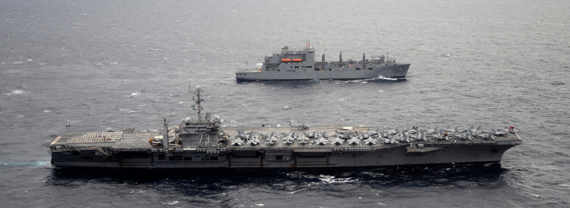 USS George Washington (CVN 73) and USNS Carl Brashear (T-AKE 7) conduct a replenishment-at-sea in waters west of the Korean Peninsula, on Dec. 2, 2010. George Washington completed a training exercise with the Republic of Korea (ROK) navy demonstrating the U.S. commitment to the ROK and regional partners in the Western Pacific. (U.S. Navy photo by Mass Communication Specialist 3rd Class Charles Oki)