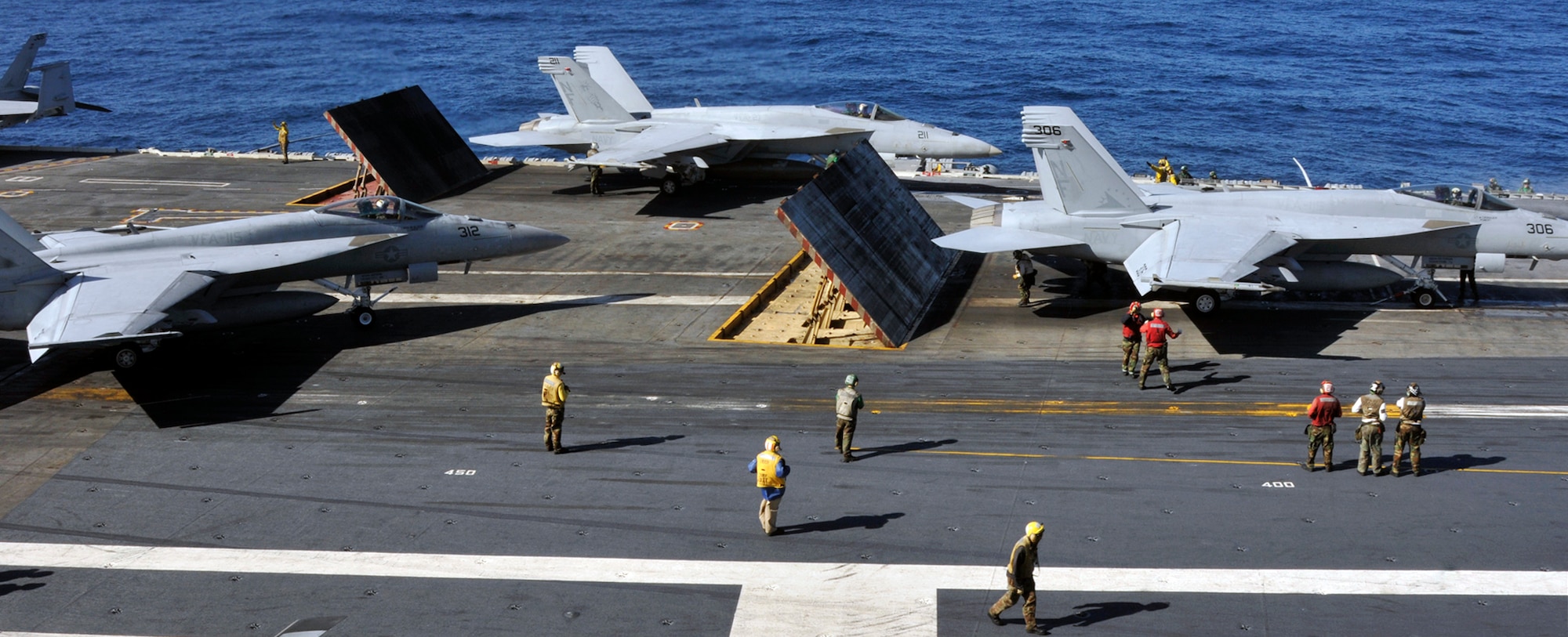PACIFIC OCERN -- Sailors aboard USS George Washington (CVN 73) position Super Hornets on the ship's flight deck, readying them to launch during flight quarters, Dec. 4. The GW is currently participating in Keen Sword 2011 with Japan Self Defense Forces. This exercise enhances the Japan-U.S. alliance which remains a key strategic relationship in the Northeast Asia Pacific region. Keen Sword caps the 50th anniversary of the Japan-U.S. alliance as an "alliance of equals." The exercise runs through Dec. 10. (U.S. Navy photo by Mass Communication Specialist 3rd Class David A. Cox)