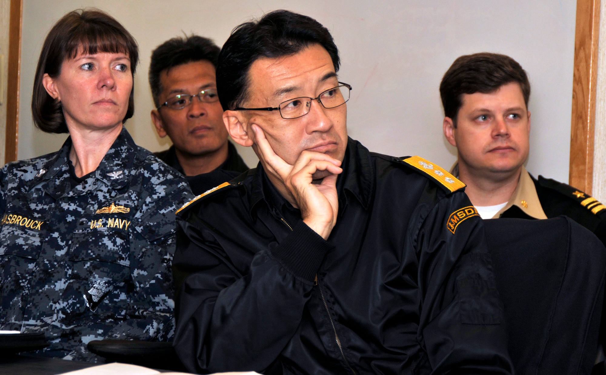 PACIFIC OCEAN -- Japan Maritime Self Defense Force's Rear Adm. Umio Ohtsuka (right) listens to a brief in the War Room aboard USS George Washington (CVN 73), Dec. 4. The GW is currently participating in Keen Sword 2011 with Japanese Self Defense Forces. This exercise enhances the Japan-U.S. alliance which remains a key strategic relationship in the Northeast Asia Pacific region. Keen Sword caps the 50th anniversary of the Japan-U.S. alliance as an "alliance of equals." The exercise runs through Dec. 10. (U.S. Navy photo by Mass Communication Specialist 3rd Class David A. Cox)