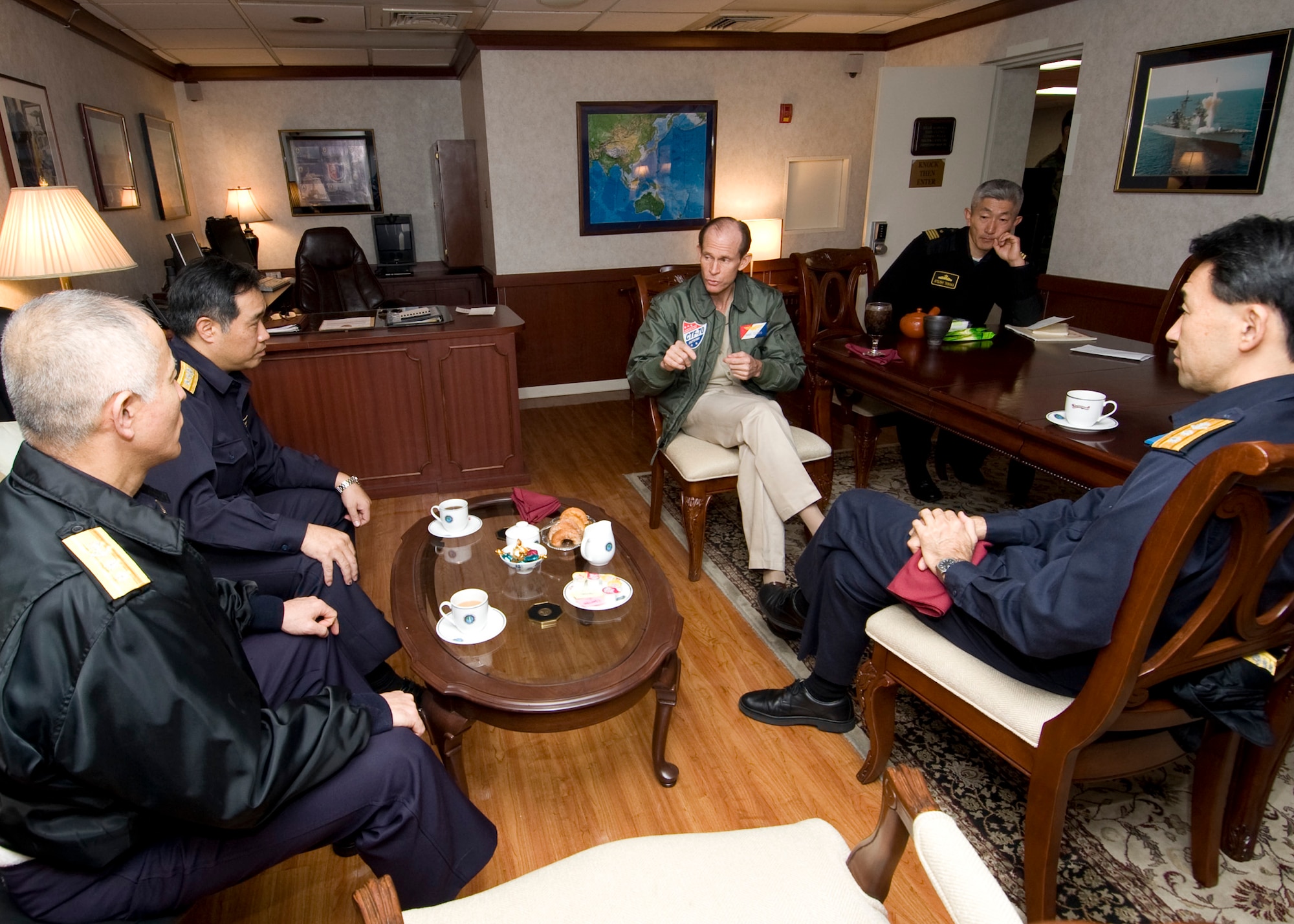 PACIFIC OCEAN -- Commander Task Force 70 (CTF 70) Rear Adm. Dan Cloyd speaks with other Japan Maritime Self Defense Force admirals about the schedule for exercise Keen Sword 2011 onboard USS George Washington (CVN 73). The GW is currently participating in Keen Sword 2011 with Japan Self Defense Forces. This exercise enhances the Japan-U.S. alliance which remains a key strategic relationship in the Northeast Asia Pacific region. Keen Sword caps the 50th anniversary of the Japan-U.S. alliance as an "alliance of equals." The exercise runs through Dec. 10. (U.S. Navy photo by Mass Communication Specialist Seaman Cheng S. Yang)