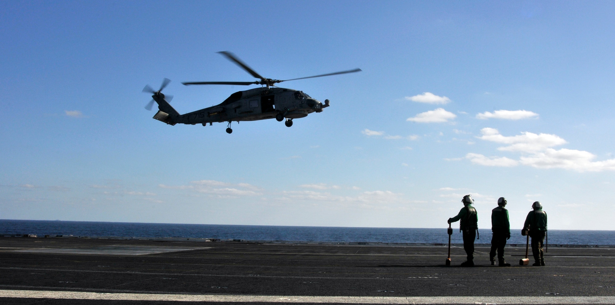 PACIFIC OCEAN - - Sailors from the "Warlords" of Helicopter Anti-Submarine Squadron Light (HSL) 51 wait for an SH-60B Seahawk to land on the flight deck aboard USS George Washington (CVN 73), Dec. 4. The GW is currently participating in Keen Sword 2011 with Japanese Self Defense Forces. This exercise enhances the Japan-U.S. alliance which remains a key strategic relationship in the Northeast Asia Pacific region. Keen Sword caps the 50th anniversary of the Japan-U.S. alliance as an "alliance of equals." The exercise runs through Dec. 10. (U.S. Navy photo by Mass Communication Specialist 3rd Class David A. Cox)