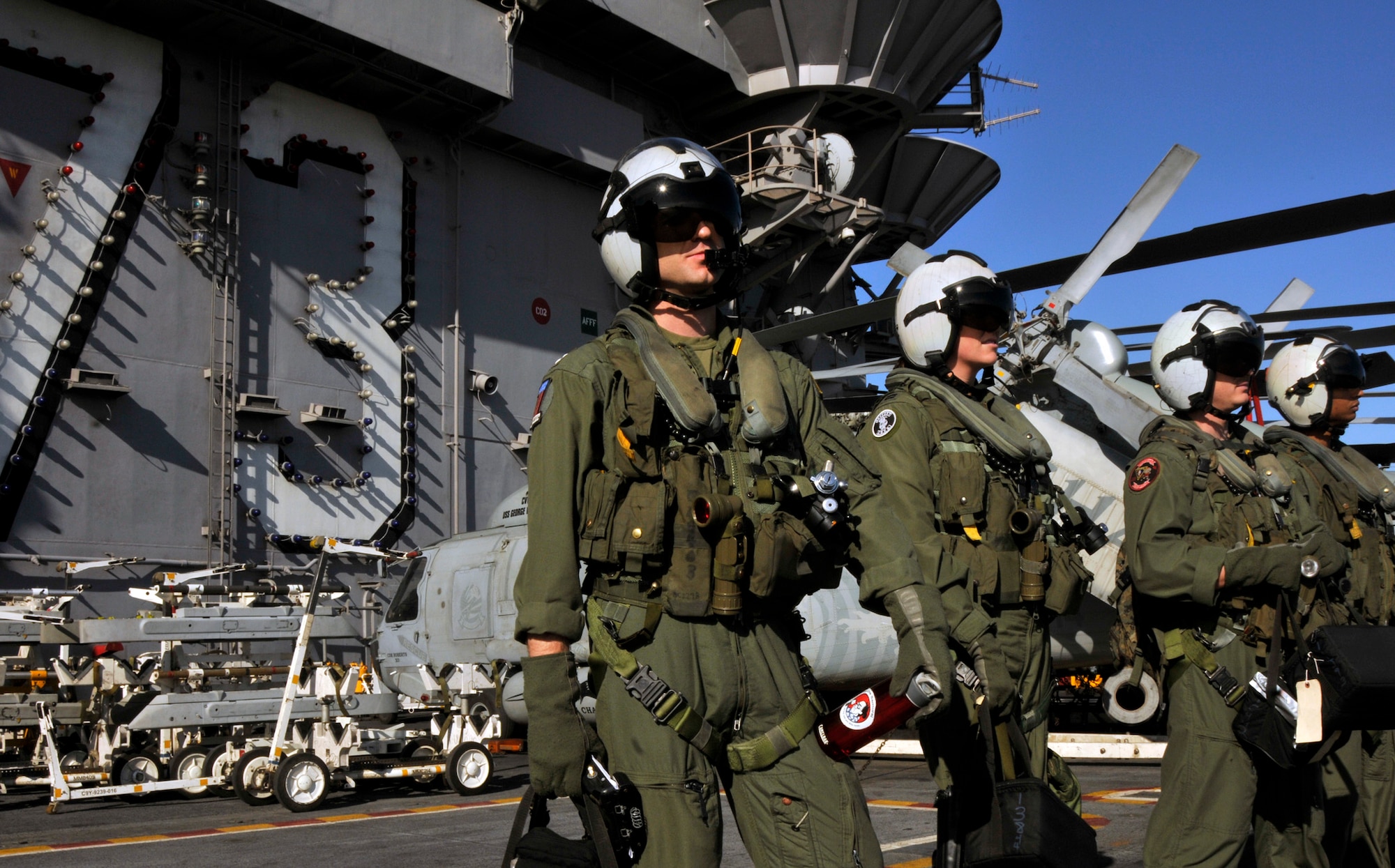PACIFIC OCEAN -- Pilots from the "Warlords" of Helicopter Anti-Submarine Squadron Light (HSL) 51 wait for an SH-60B Seahawk on the flight deck aboard USS George Washington (CVN 73), Dec. 4. The GW is currently participating in Keen Sword 2011 with Japanese Self Defense Forces. This exercise enhances the Japan-U.S. alliance which remains a key strategic relationship in the Northeast Asia Pacific region. Keen Sword caps the 50th anniversary of the Japan-U.S. alliance as an "alliance of equals." The exercise runs through Dec. 10. (U.S. Navy photo by Mass Communication Specialist 3rd Class David A. Cox)