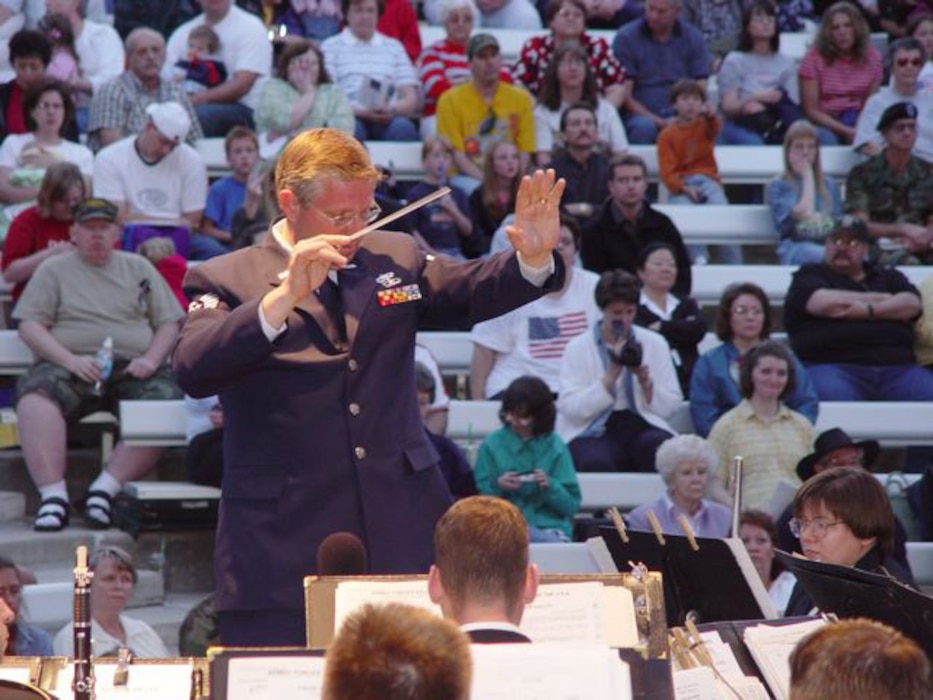 Tech. Sgt. Sterling Poulson, the Public Affairs Non-Commissioned Officer in Charge for Utah Air National Guard State Headquarters, conducts the annual Armed Forces Day concert in 2003. Sergeant Poulson is a traditional Air Guardsman as well as a local weatherman at KUTV 2News in Salt Lake City, Utah. Sergeant Poulson has a strong interest in music, and he founded the Choral Arts Society of Utah in 1987. As the music director of this 100-voice choir, he collaborated several times with the Utah Guard's 23rd Army Band for events like the Armed Forces Day concert. (U.S. Air Force photo by Master Sgt. Pat Valdez RELEASED)