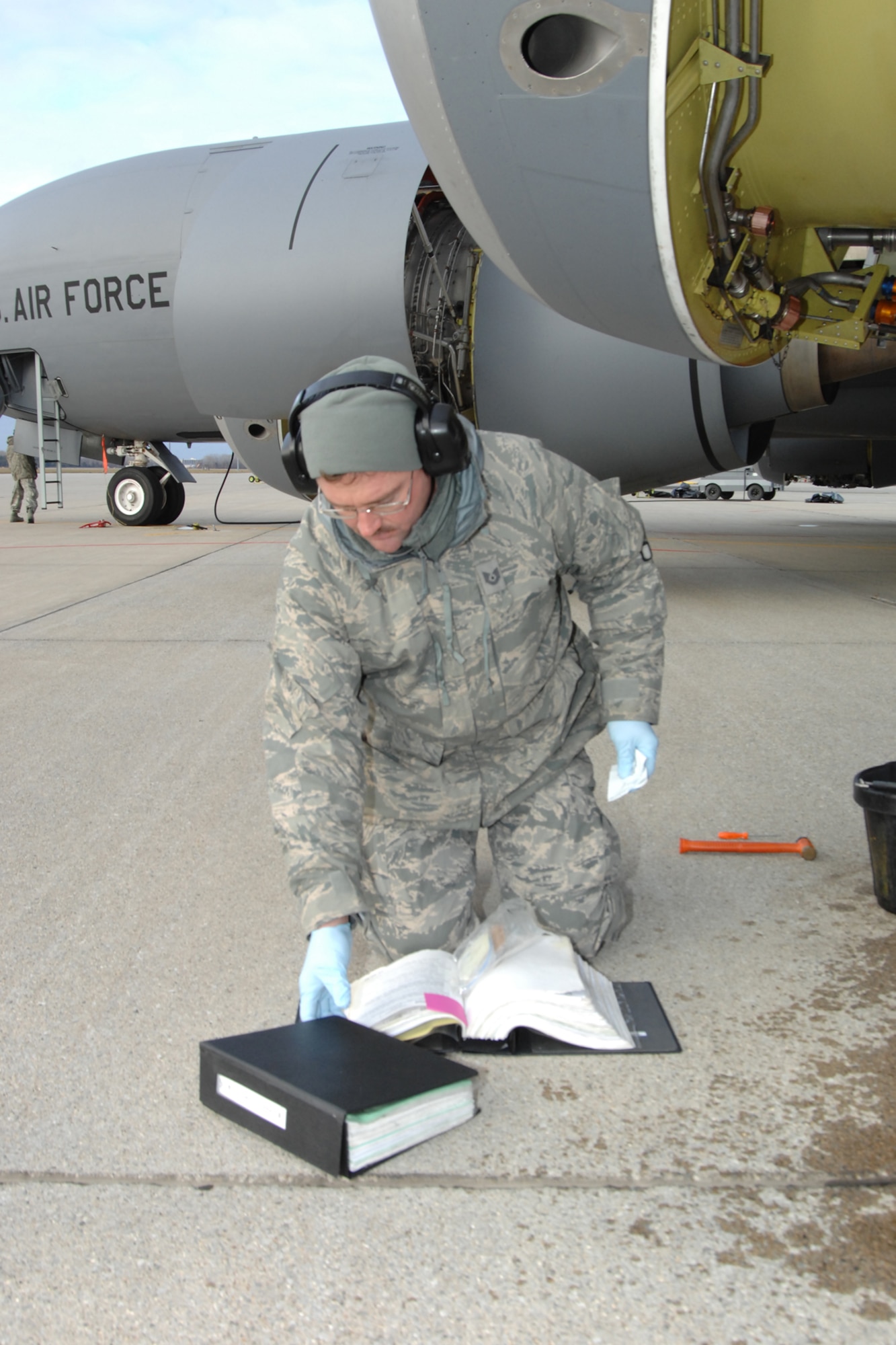 Technical Sgt. Richard Fisher reviews an Air Force technical order prior to performing routine maintenance on the engine of a KC-135 Stratotanker at Selfridge Air National Guard Base, Mich., Dec. 4, 2010. Maintenance personnel at Selfridge perform a series of regular inspections and preventative maintenance actions to ensure the KC-135s are mission ready. (U.S. Air Force photo by TSgt. Dan Heaton) (RELEASED)