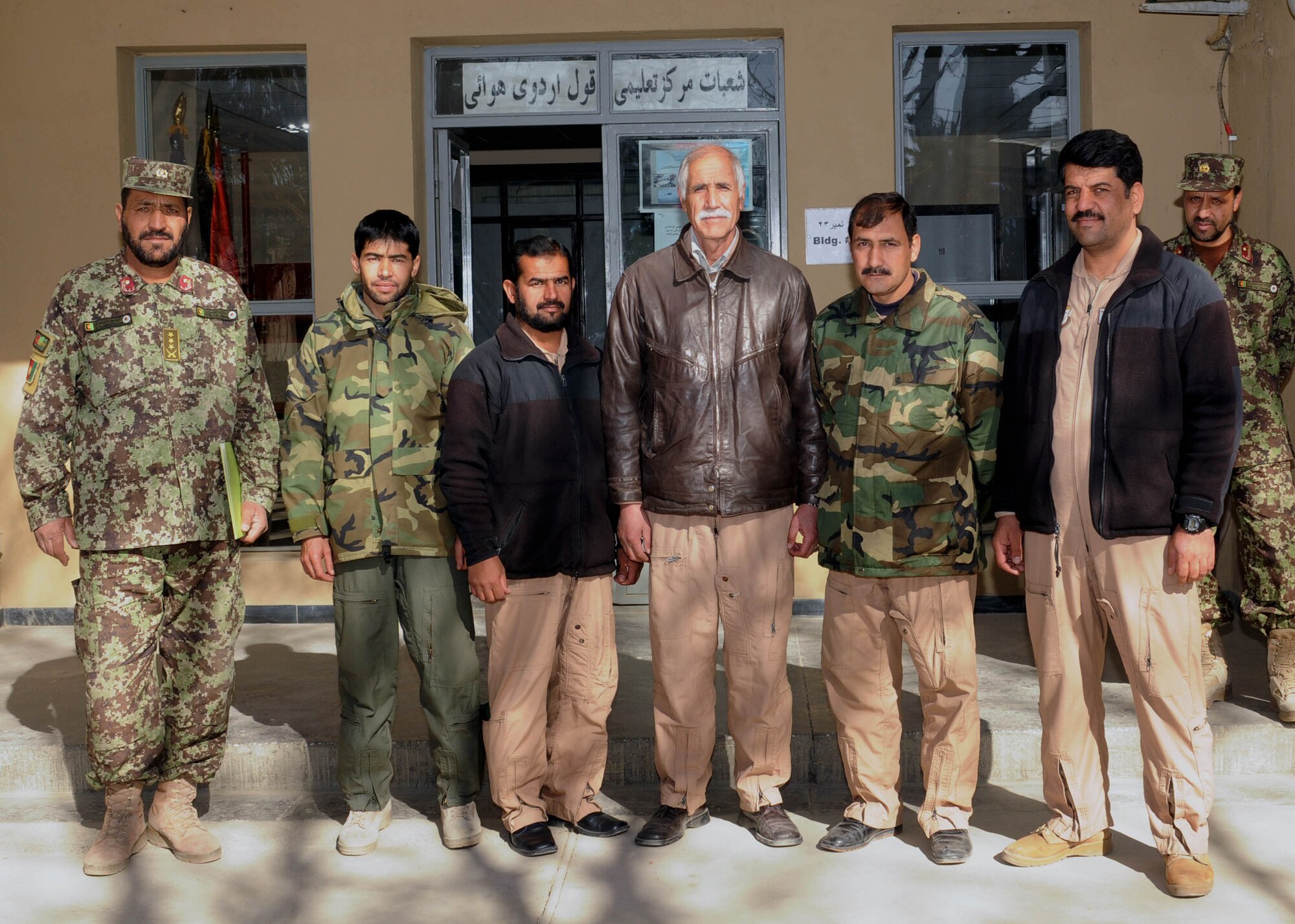 101204-N-6541W-005 KABUL, Afghanistan - Afghan Air Force Airmen graduate from the C-27 load master course at Pohantoon-e-Hawayee, the Afghan Air Force's "Big Air School" pose with Afghan Advisors on Dec. 4th.  (U.S. Navy photo by Mass Communication Specialist 3rd Class Jared Walker/ RELEASED).