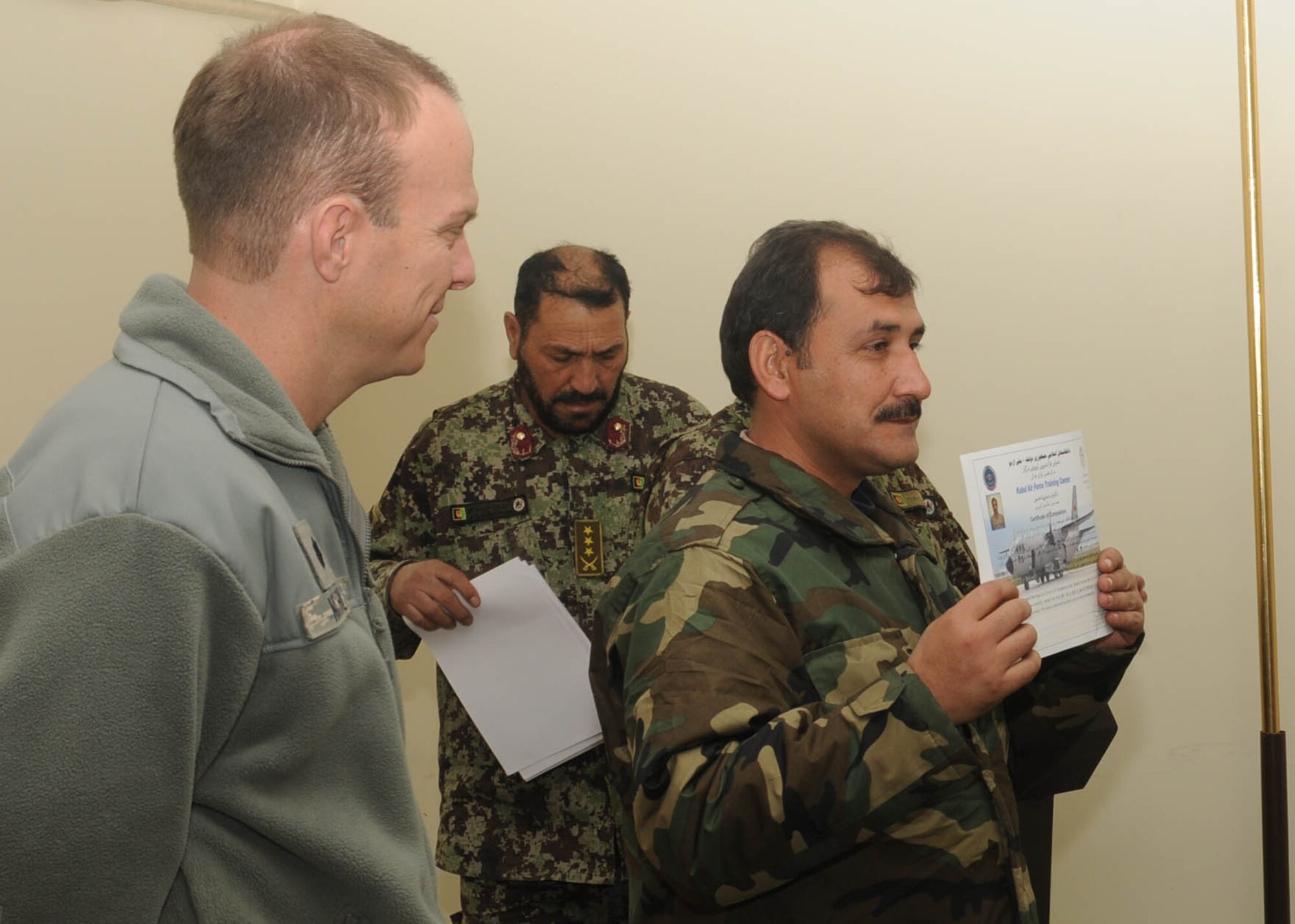 101204-N-6541W-005 KABUL, Afghanistan - Afghan Air Force Airmen graduate from the C-27 load master course at Pohantoon-e-Hawayee, the Afghan Air Force's "Big Air School" pose with Afghan Advisors on Dec. 4th.  (U.S. Navy photo by Mass Communication Specialist 3rd Class Jared Walker/ RELEASED).
