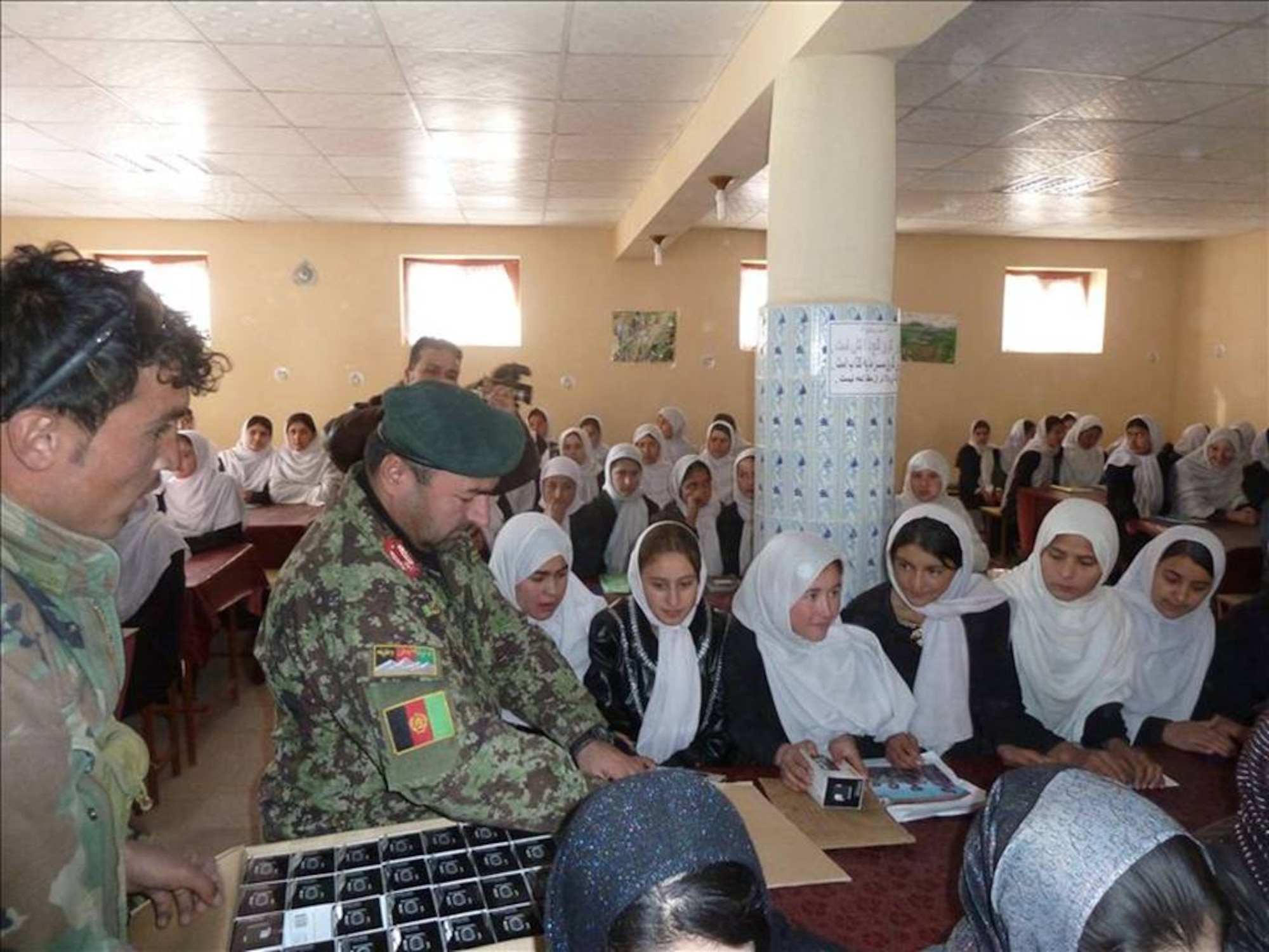 MAZAR-E-SHARIF, Afghanistan -- Members of the Afghan Air Force, Afghan National Army and NATO Air Training Command-Afghanistan advisors distributed 500 solar powered, hand-cranked radios, provided by Radio Azadi/Radio Liberty to two Feyzabad schools and villages on Dec 2.  (U.S. Air Force photo/RELEASED).