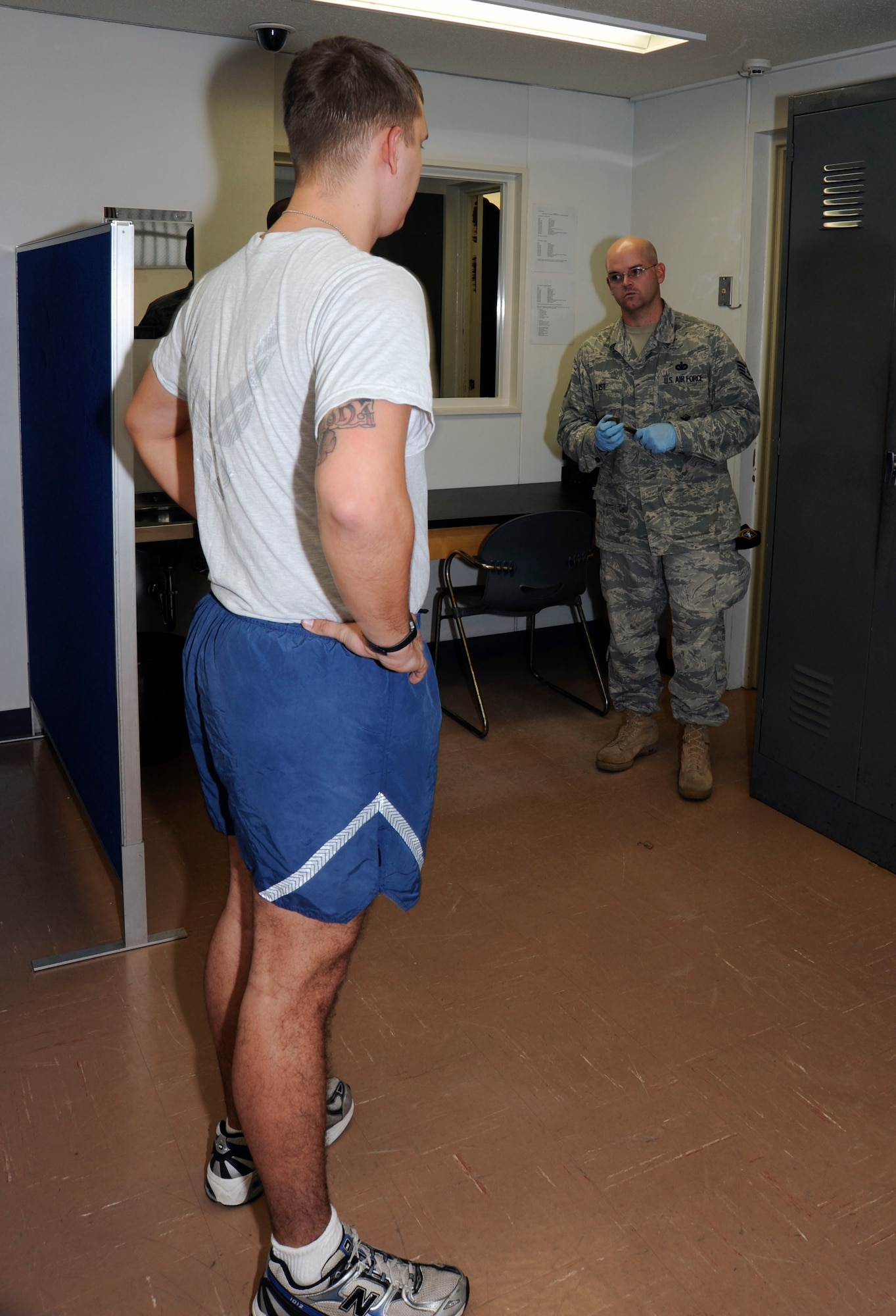 A detainee performs physical training under the watchful eye of the 35th Security Forces Squadron at Misawa Air Base, Japan, Nov. 29, 2010. While in this general population phase, the inmate's life is scripted from wake up call to lights out, to include detailed tasks, meals, PT, hygiene, and visitation. (U.S. Air Force photo by Tech. Sgt. Russell McBride/Released)