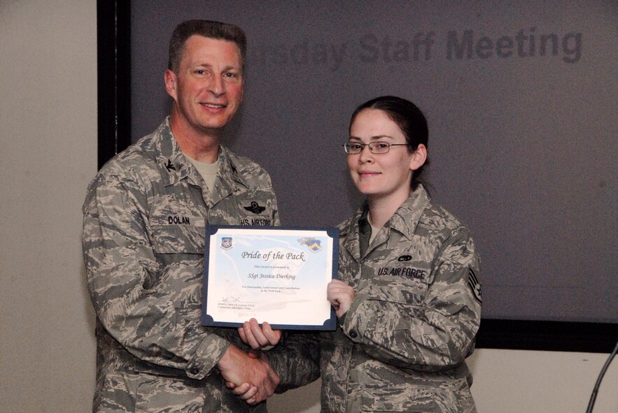 KUNSAN AIR BASE, Republic of Korea -- Col. John Dolan, 8th Fighter Wing commander, presents Staff Sgt. Jessica Dierking, 8th Maintenance Squadron, with a Pride of the Pack award Dec. 3. (U.S. Air Force photo/Capt. Sheryll Klinkel)
