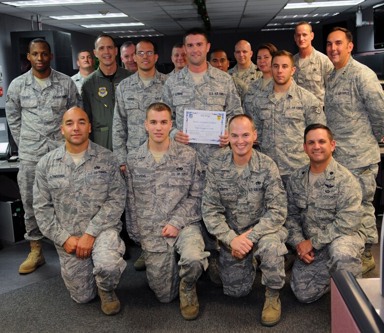 Brig. Gen. John Doucette awards Staff Sgt. Mike Lewis an Aerial Port Capability Forecaster with the 734th Air Mobility Squadron, with Andersen's Best here Dec. 3. Sergeant Lewis is an essential part of the unit, monitoring and directing aerial port ground operations with tenant and host base agencies identifying and redirecting passenger and equipment to ensure safe, effective and efficient mission accomplishment. For his outstanding performance, dedication, commitment to excellence and actions above and beyond expectations, the 734th AMS and wing leadership dub him Andersen's Best.As aerial port lead for exercise Phoenix Cooper he lead the movement of 388 personnel, 95 tons and 18 missions with no delays. During Valiant Shield he coordinated the movement of 615 tons of equipment, 1,600 passengers with more than 105 missions enabling 125 aircraft with more than 880 sorties in 10 days. For his outstanding performance, dedication, commitment to excellence and actions above and beyond expectations, the 734th AMS and wing leadership dub him Andersen's Best.(U.S. Air Force photo/ Senior Airman Nichelle Anderson)