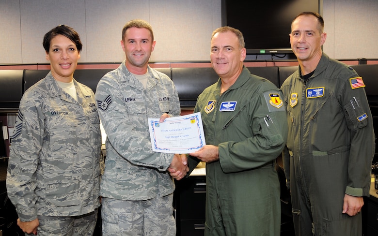 Brig. Gen. John Doucette awards Staff Sgt. Mike Lewis an Aerial Port Capability Forecaster with the 734th Air Mobility Squadron, with Andersen's Best here Dec. 3.As aerial port capability forecaster, Sergeant Lewis coordinates cargo and passenger airlift requirements with the Tactical Air Control Center as well as coordinating all inbound and outbound munitions airlift movements. Sergeant Lewis is an essential part of the unit, monitoring and directing aerial port ground operations with tenant and host base agencies identifying and redirecting passenger and equipment to ensure safe, effective and efficient mission accomplishment. For his outstanding performance, dedication, commitment to excellence and actions above and beyond expectations, the 734th AMS and wing leadership dub him Andersen's Best. (U.S. Air Force photo/ Senior Airman Nichelle Anderson)