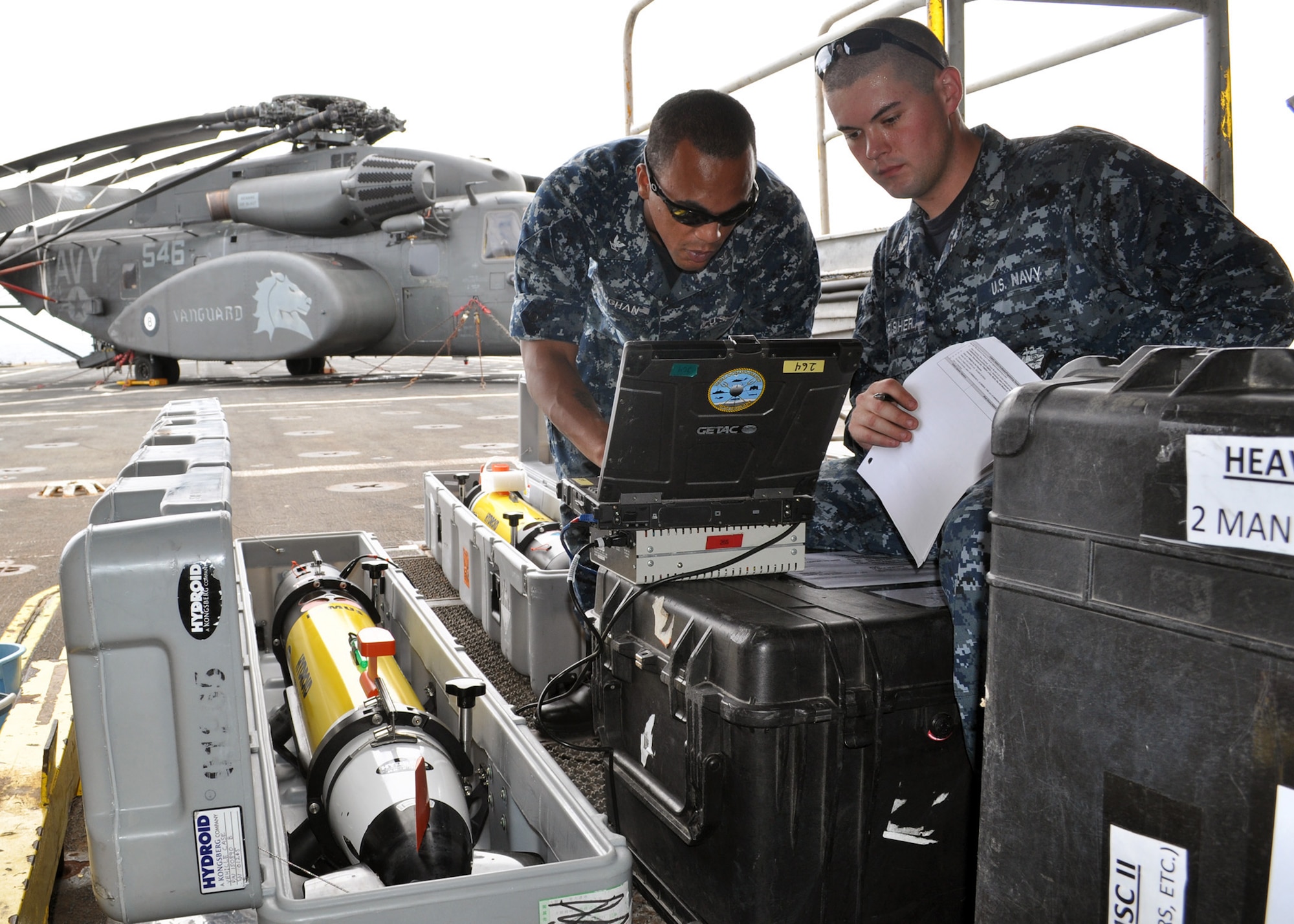 Aerographer's Mate 3rdClass Ryan Vaughan (left) and Aerographer's Mate Jason Fisher run diagnostics on a remote environmental monitoring unit (REMUS 100) aboard theamphibious transport dock USS Denver (LPD 9) in the East China Sea on Dec. 5, 2010. The REMUS 100 is an unmanned undersea vehicle (UUV) that is used for mine detection. These operations mark the first ever launch of a UUV from an LPD-platform ship. Denver is part of the permanently forward-deployed Essex Amphibious Ready Group and is underway participating in Keen Sword 2011, a joint defense exercise with the Japan Maritime Self-Defense Force (JMSDF). (U.S. Navy photo by Mass Communication Specialist 3rd Class Bryan
Blair)